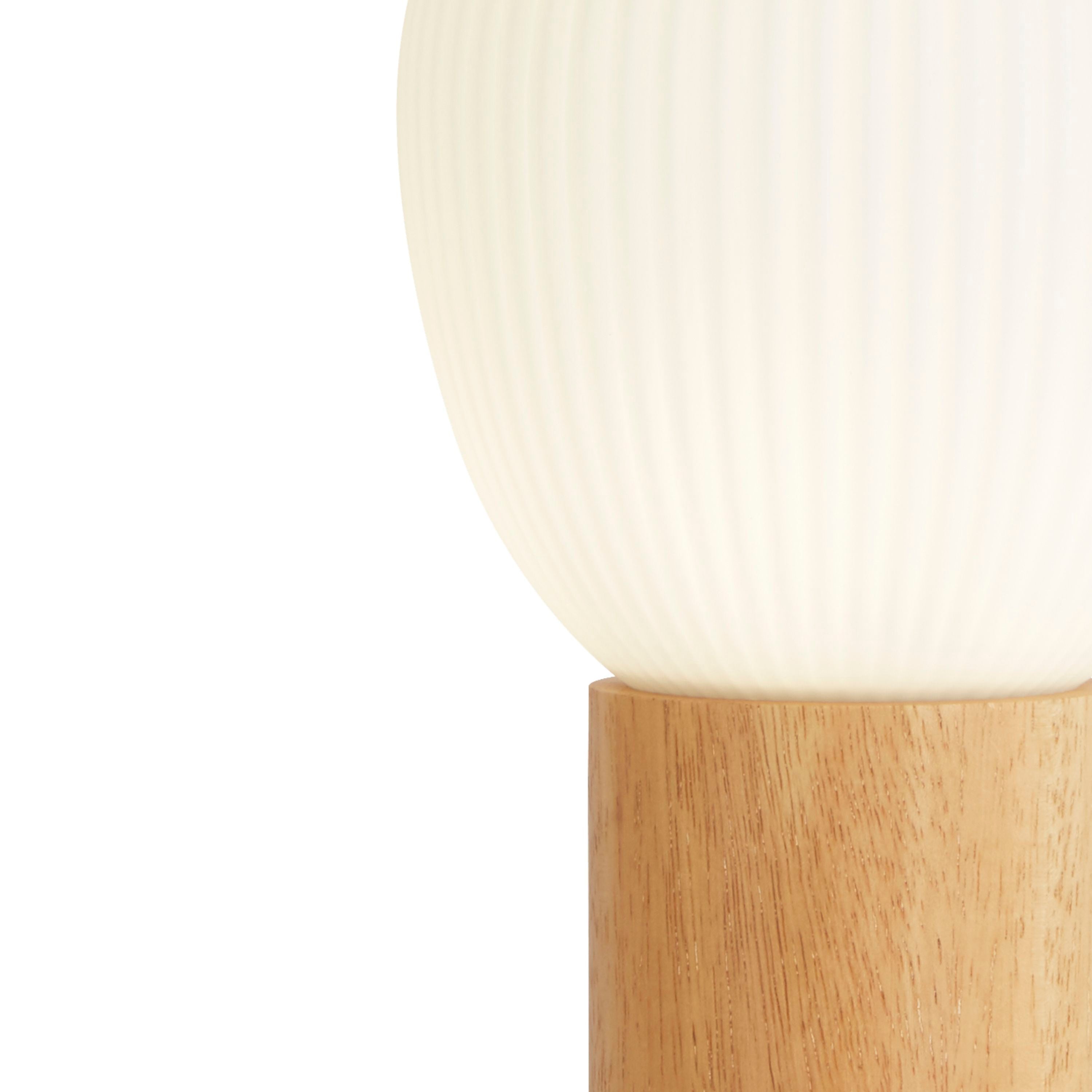 Close up of the Searchlight Ella table lamp showing the ribbed texture of the opal glass shade meeting the beech wood collar