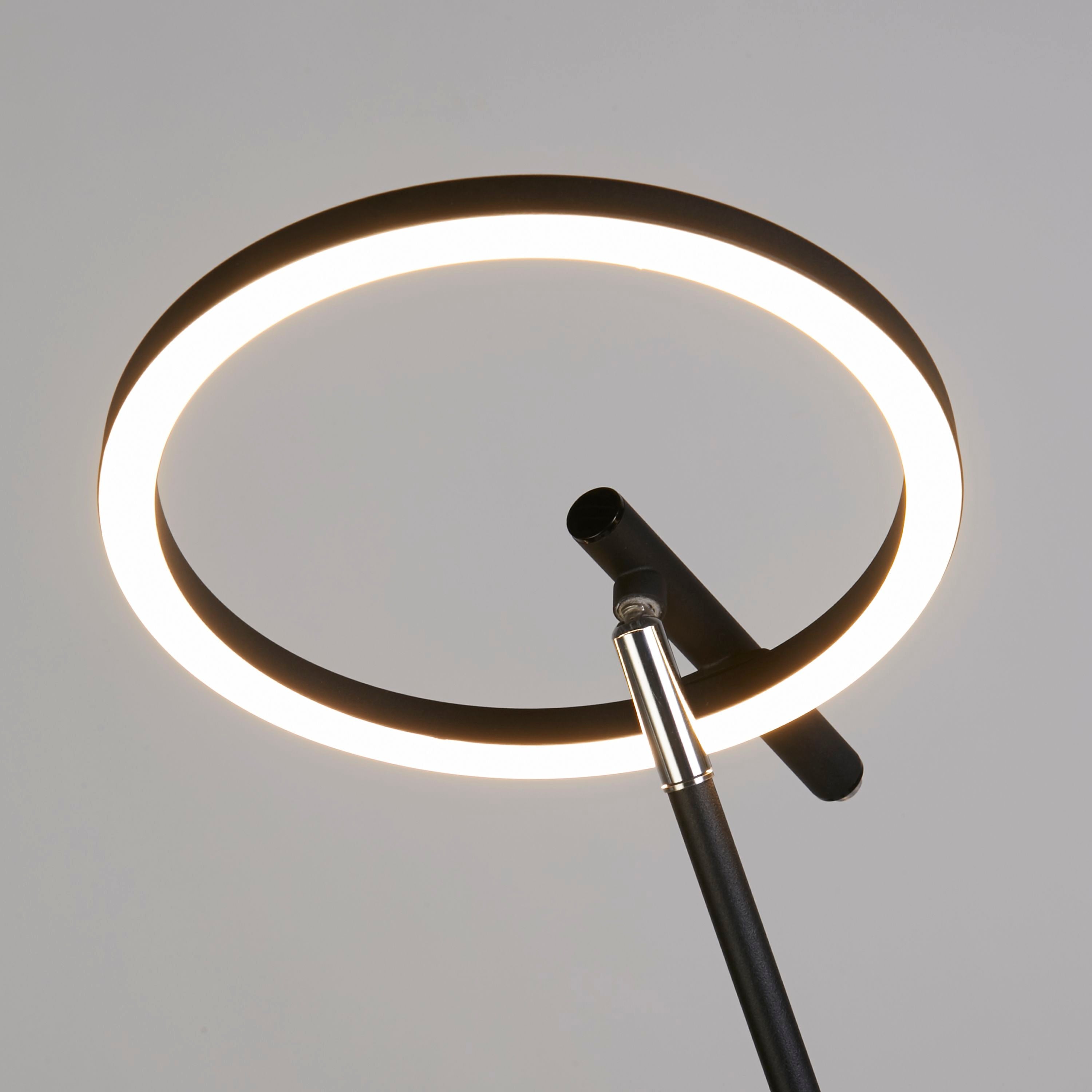 Close up of the Space floor lamp's ring head and chrome jointed arm, showing how the head pivots and tilts to direct light