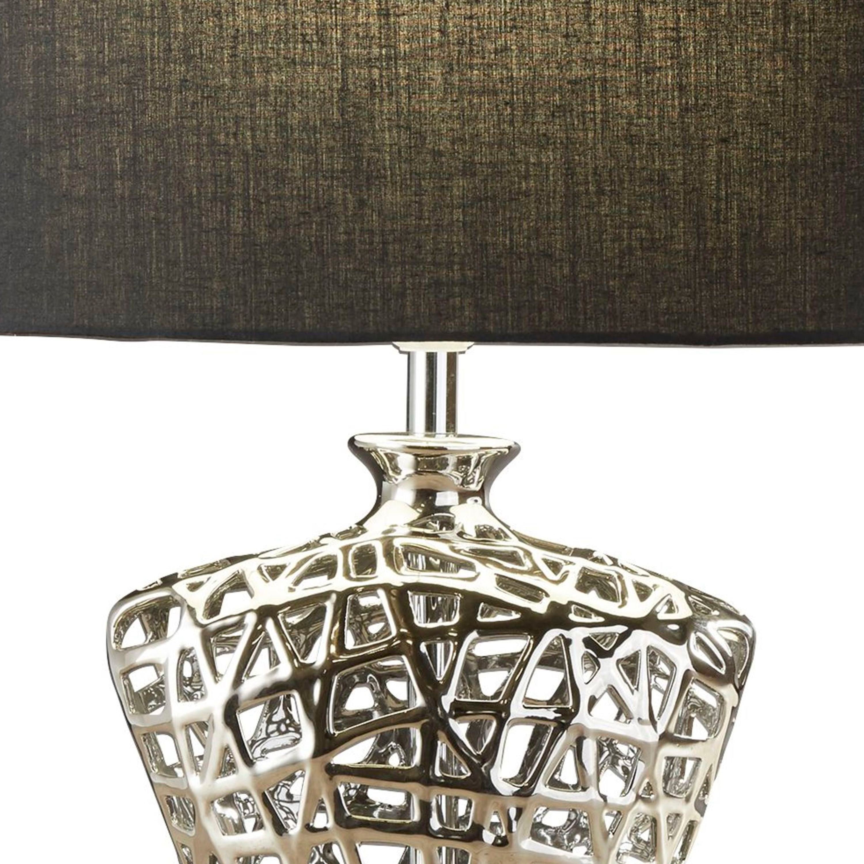 Close up of the Network table lamp's neck and cut out ceramic base, showing the chrome effect glaze in detail