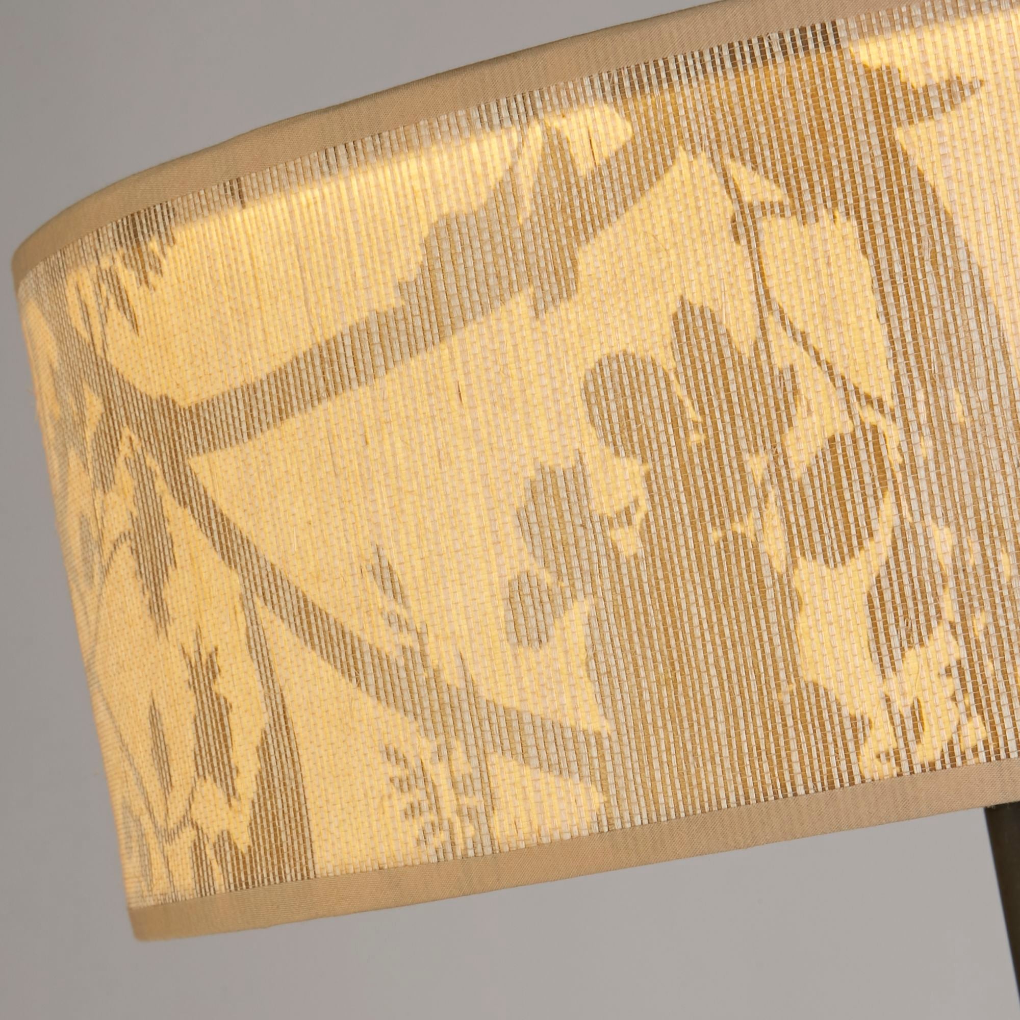 Close up of the Isla Floor Lamp's shade fabric, showing the woven leaf print texture and stitched edge trim against the black stem