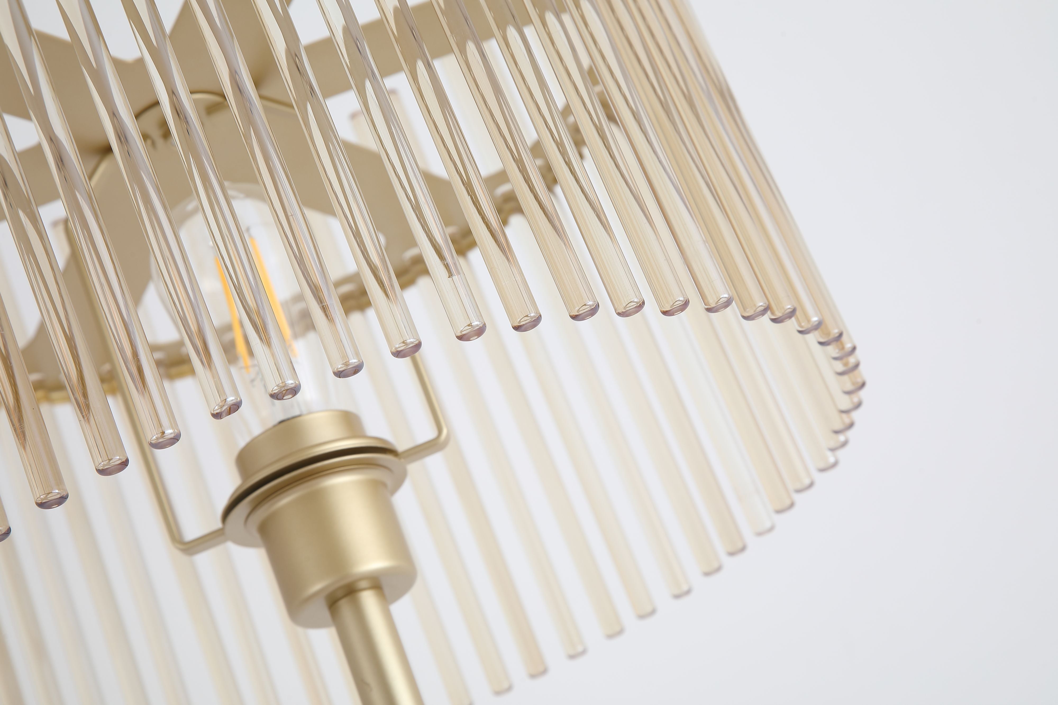 Close up of the Swizzle floor lamp shade, showing the champagne glass rods and exposed bulb glowing through them
