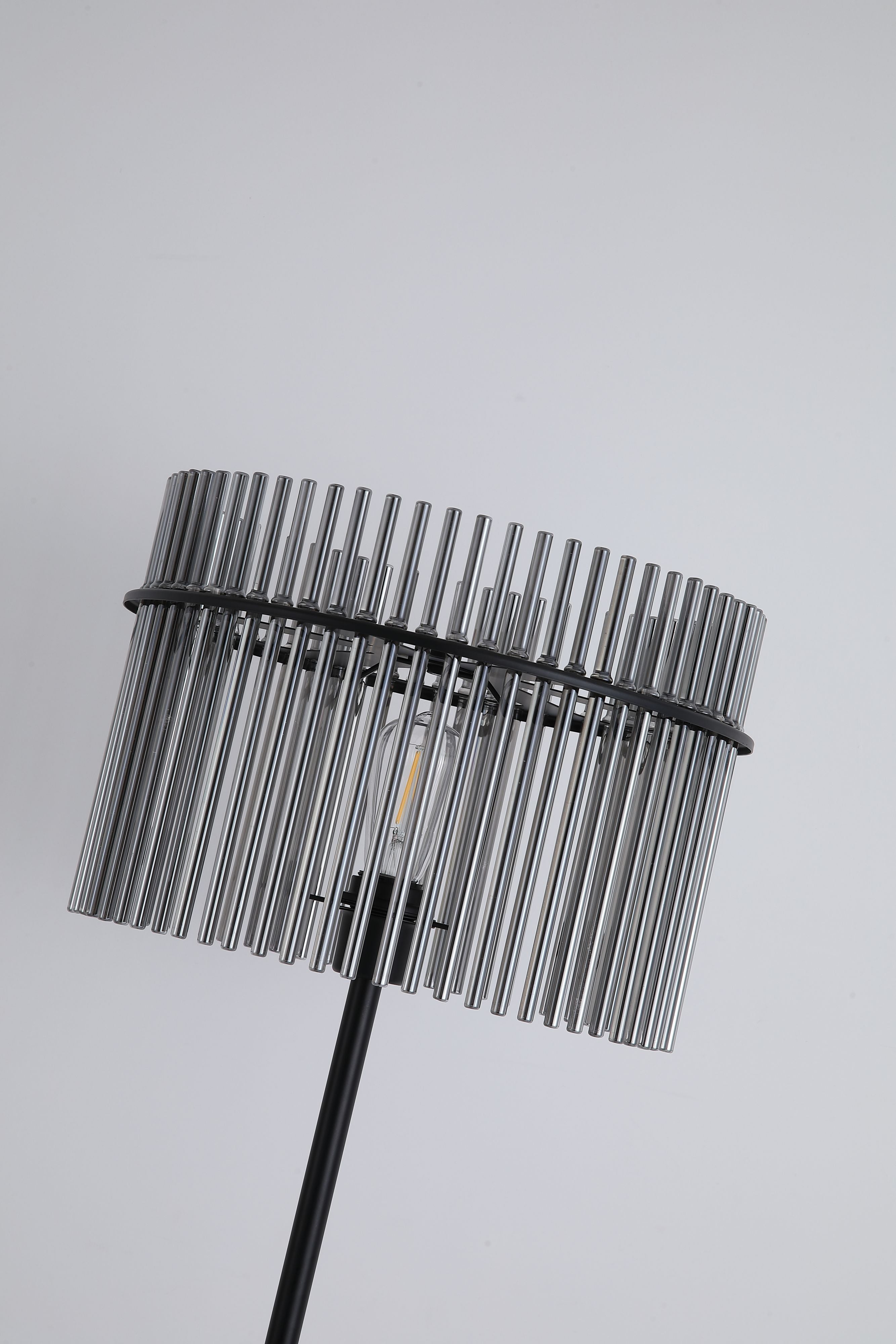 Close up of the Swizzle floor lamp shade, showing the smoked glass rods and exposed bulb glowing through them