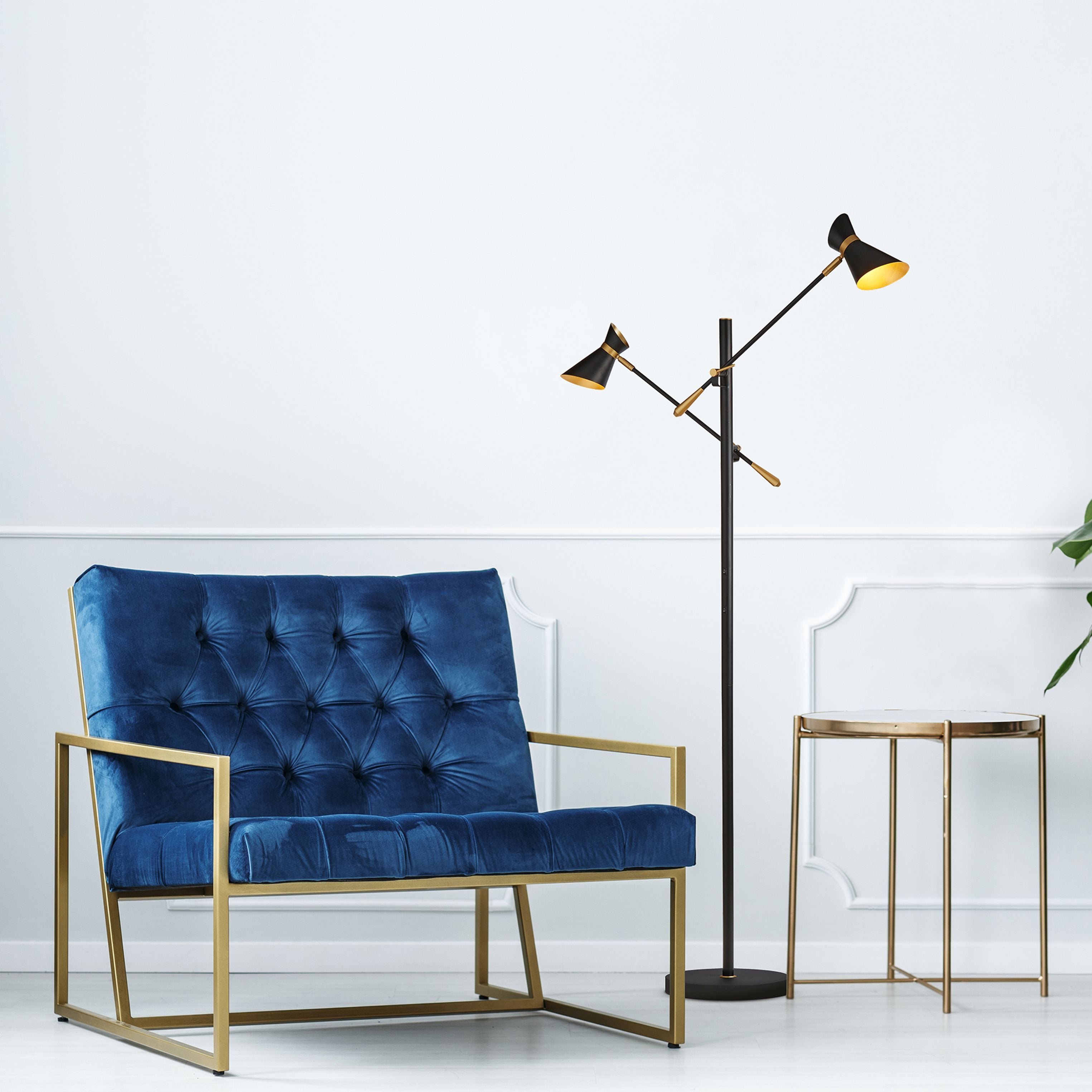 Searchlight Diablo 2 light floor lamp styled in a living room beside a navy velvet armchair and brass side table, both shades lit