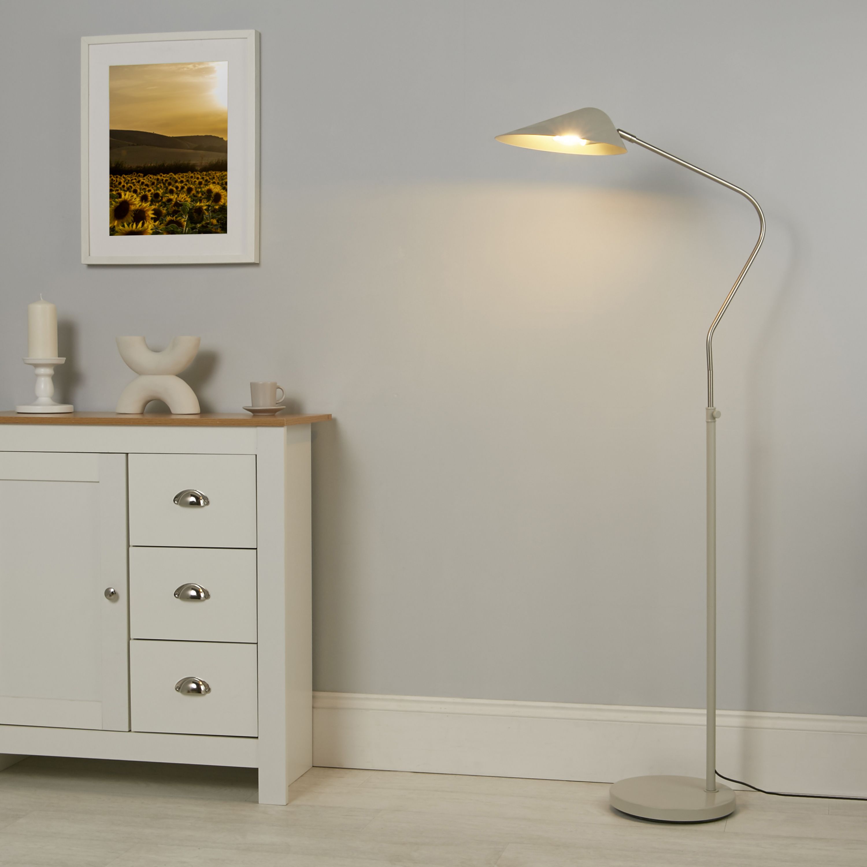 Searchlight Swan Floor Lamp styled in a light grey living room beside a sideboard and framed picture
