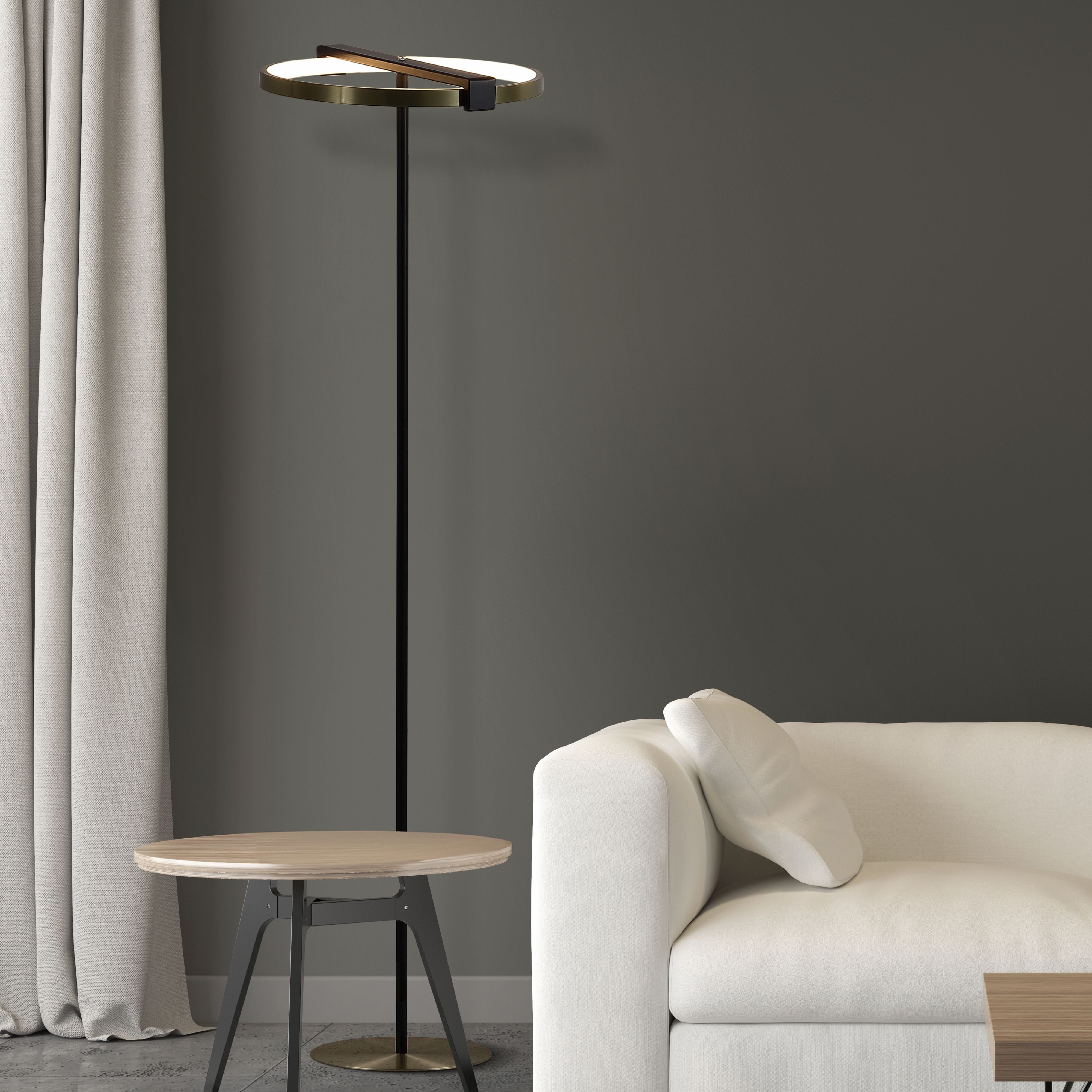 Searchlight Aerial LED Floor Lamp styled beside a cream sofa and curtains in a living room, ring lit warm white