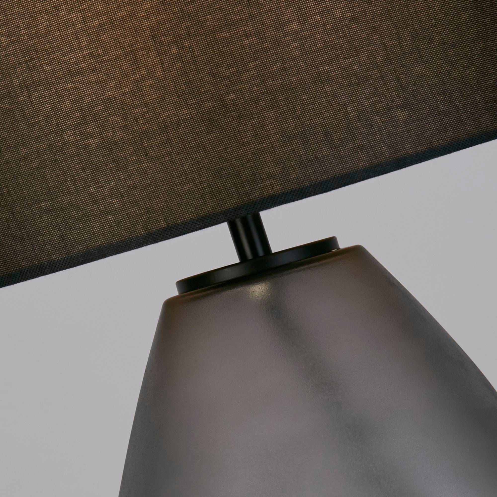 Close up of the Devon black table lamp chrome coloured neck collar and dimpled frosted glass texture
