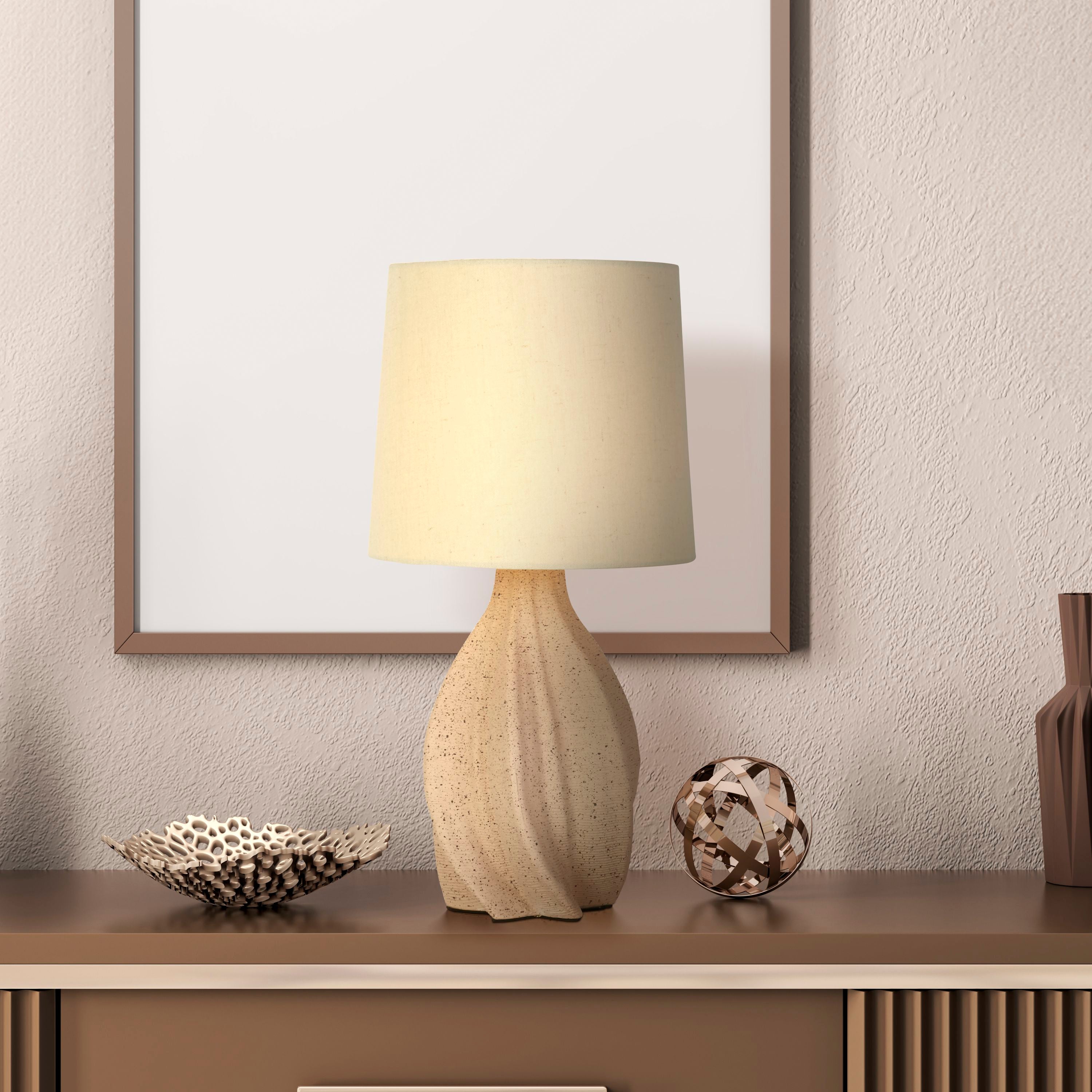 Twist table lamp styled on a console shelf next to a framed print, ceramic dish and decorative sphere