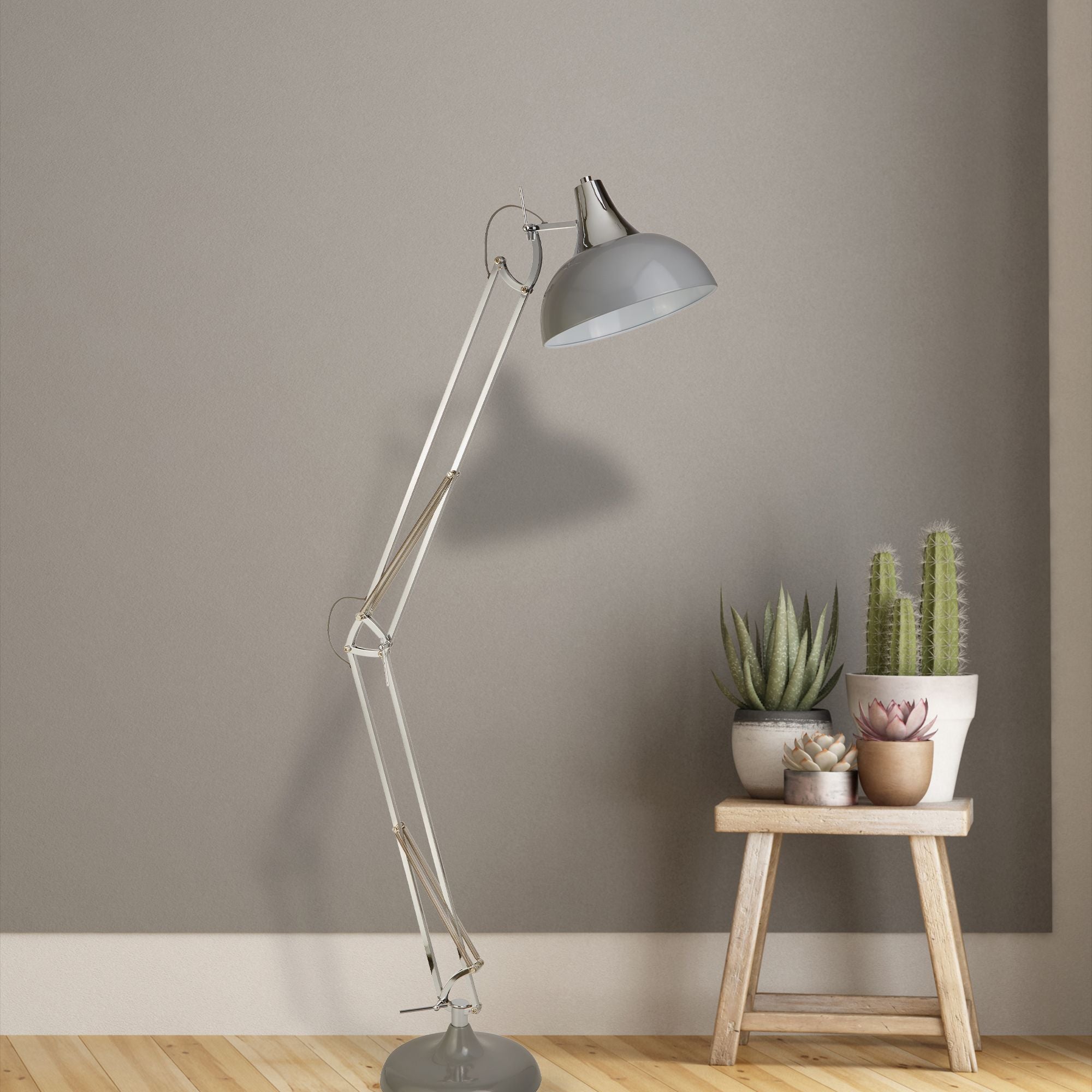 Searchlight Goliath Task Lamp styled in a living room beside a wooden stool with potted succulents