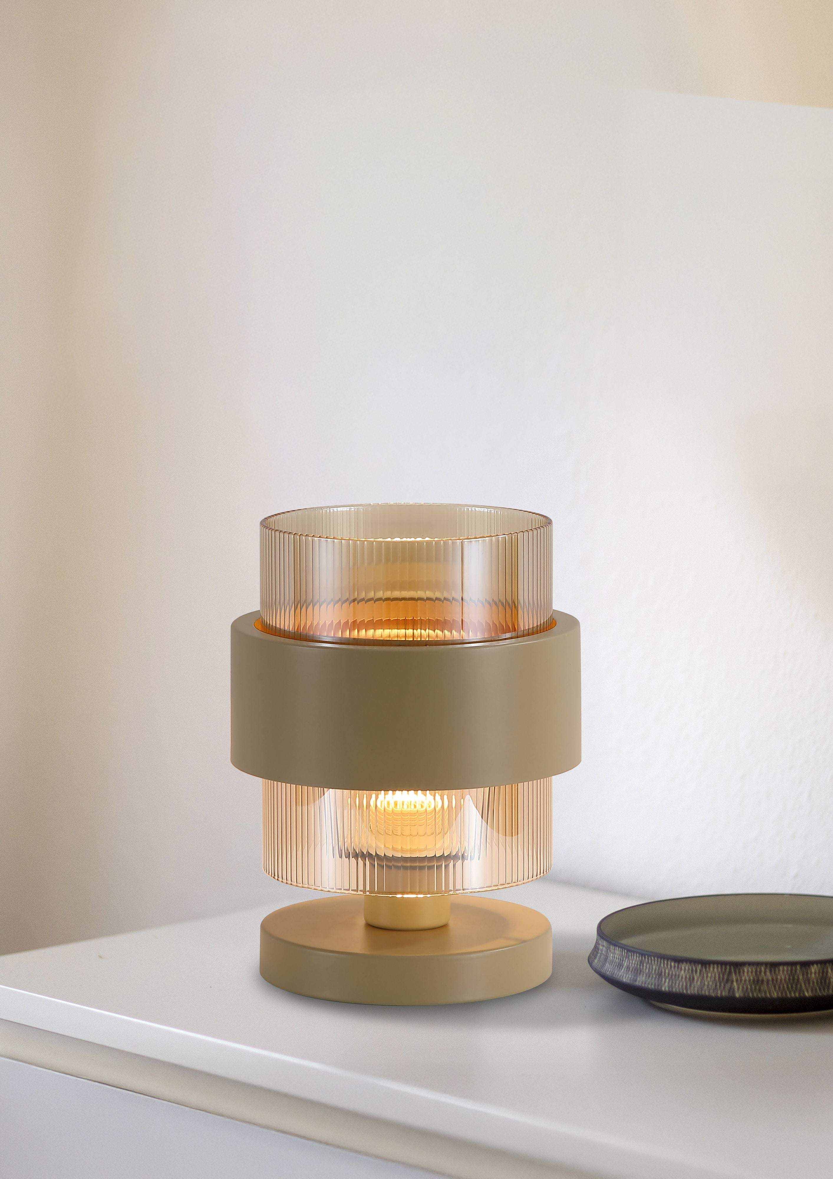 Searchlight Royal Table Lamp styled lit on a console table beside a ceramic plate