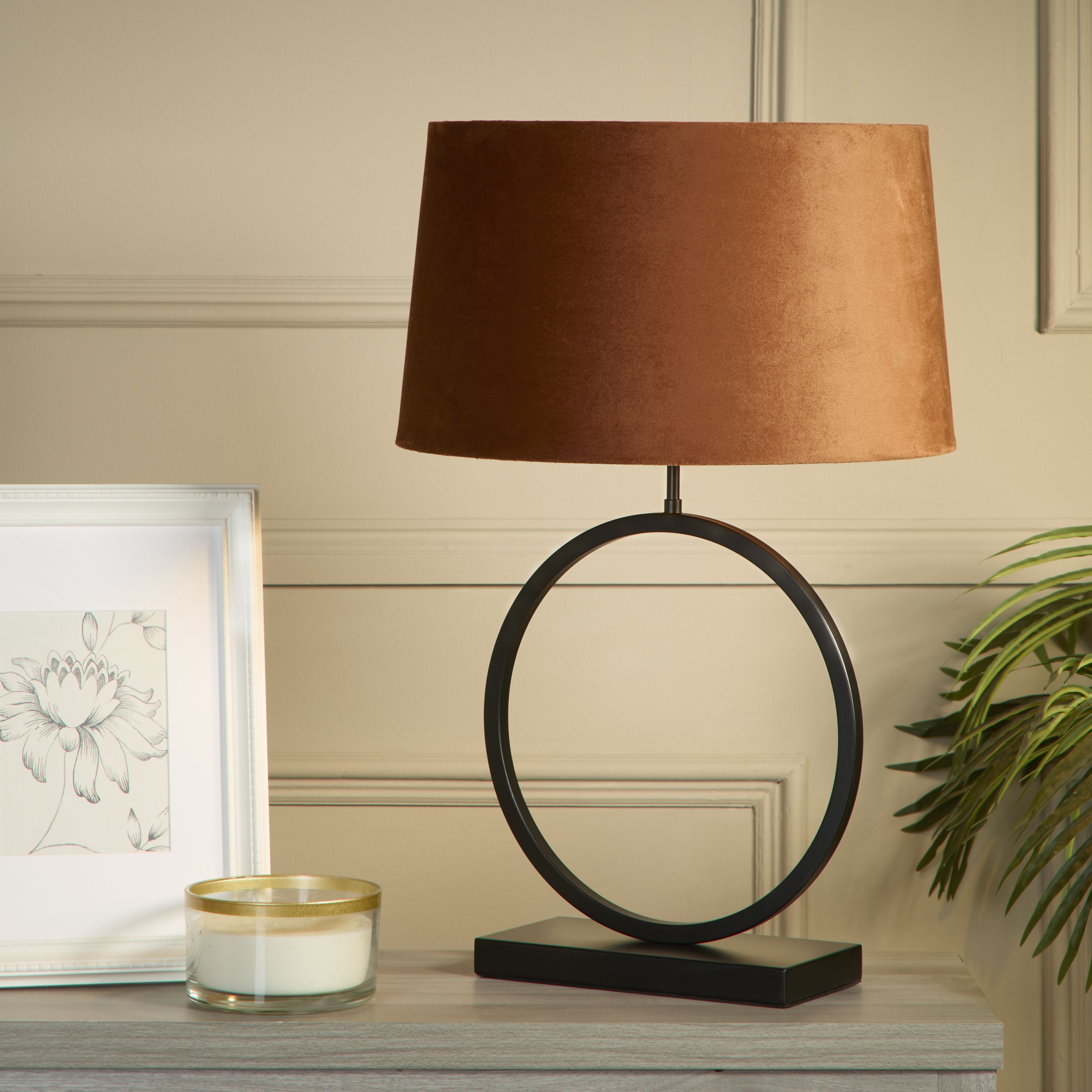 Elegant Table Lamp with burnt orange velvet shade styled on a console table next to a framed print, candle and a leafy plant