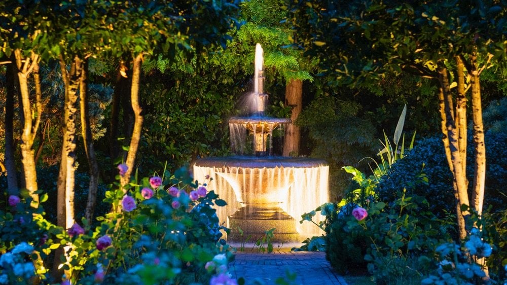Glowing fountain in a garden at night