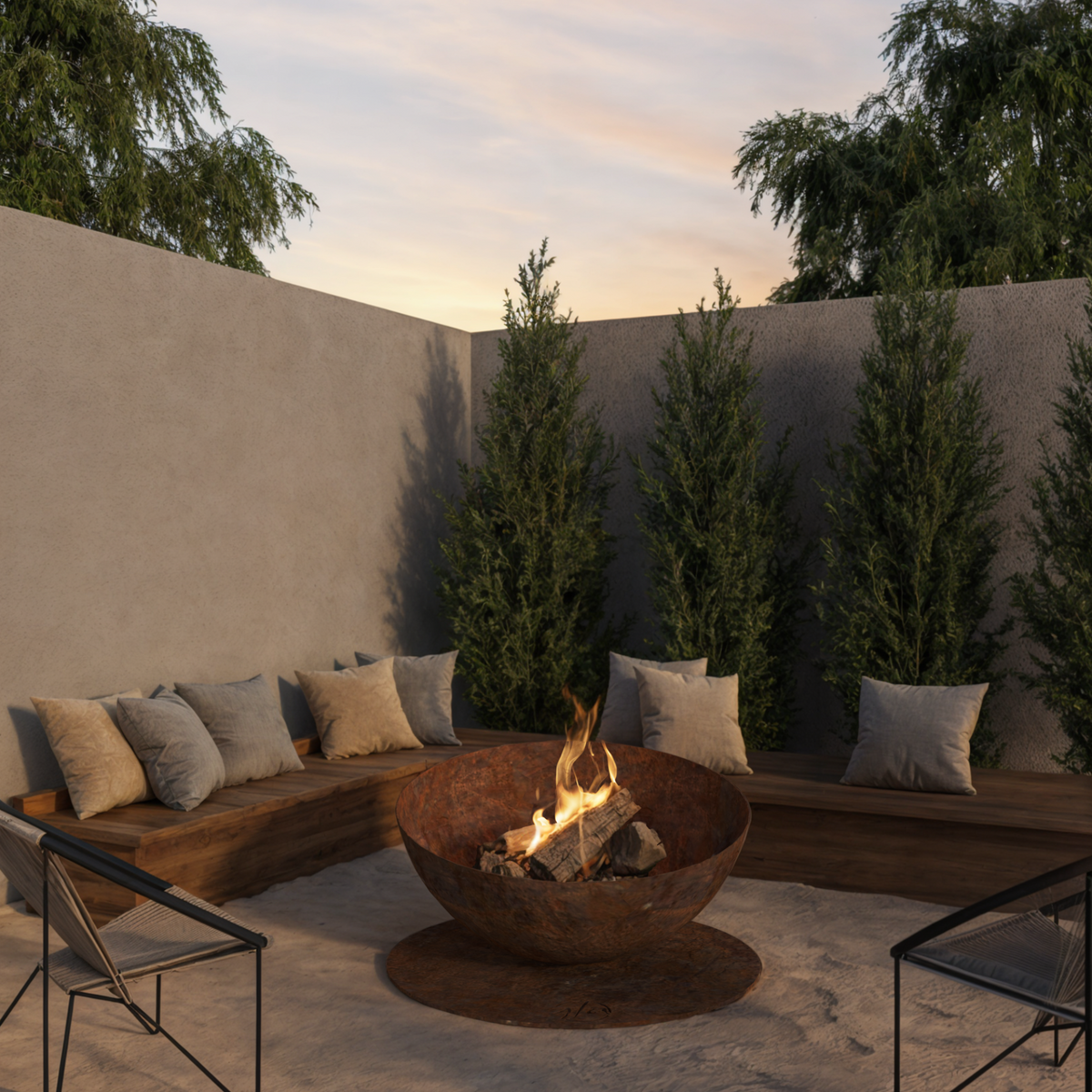 GlammFire Solace wood burning fire pit positioned within a landscaped outdoor seating area with sofas and planting