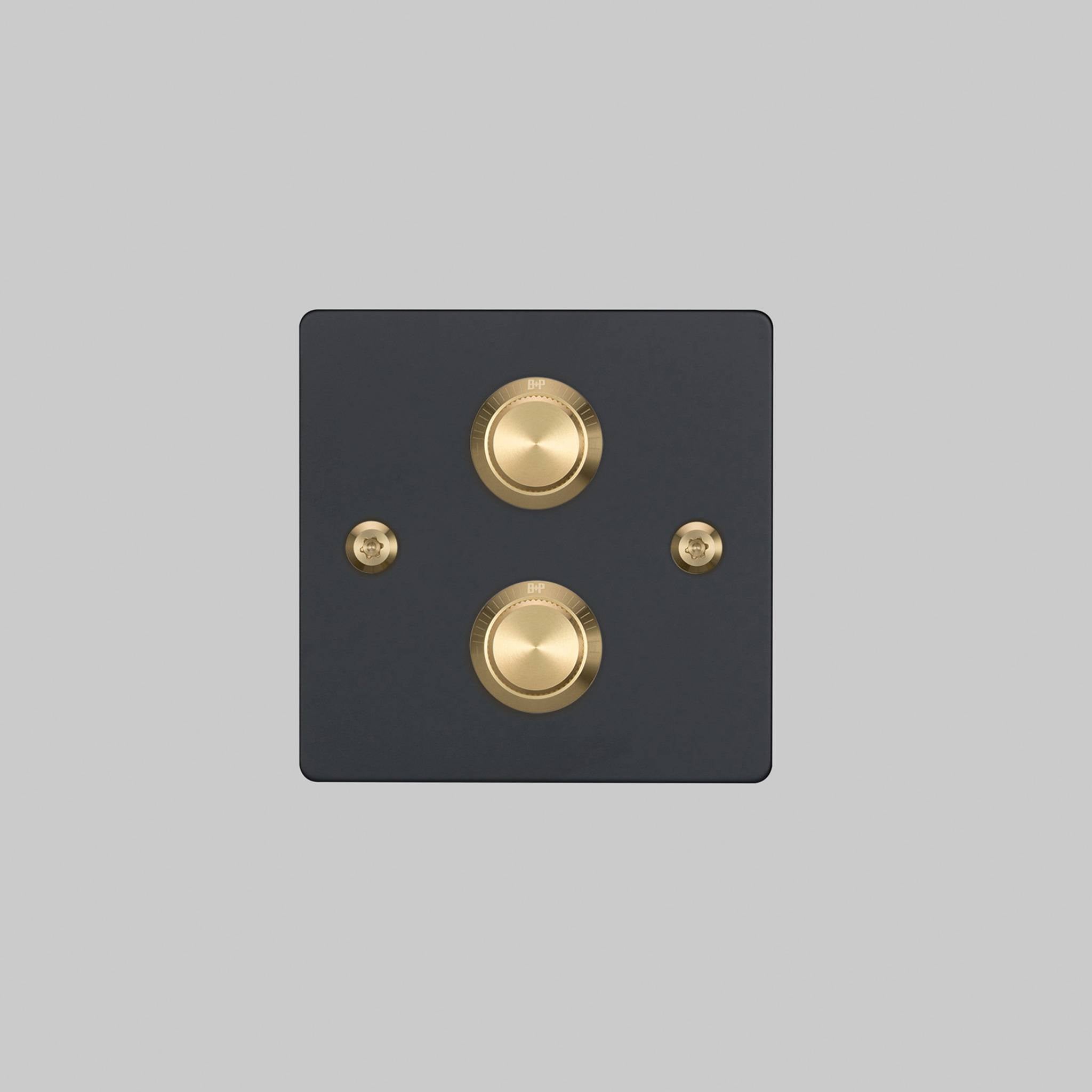 Buster + Punch 2G dimmer switch, black plate with brass linear knurl knobs, front elevation