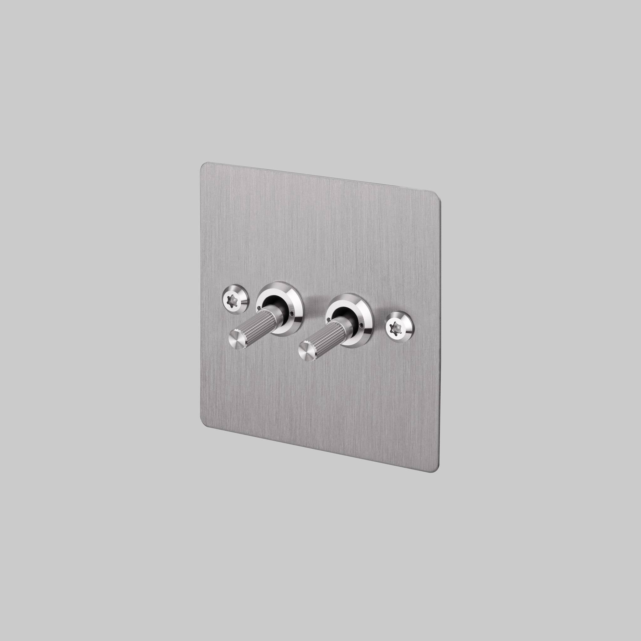 Buster + Punch 2G 2-way toggle switch, steel plate with steel linear knurl toggle arm, front view
