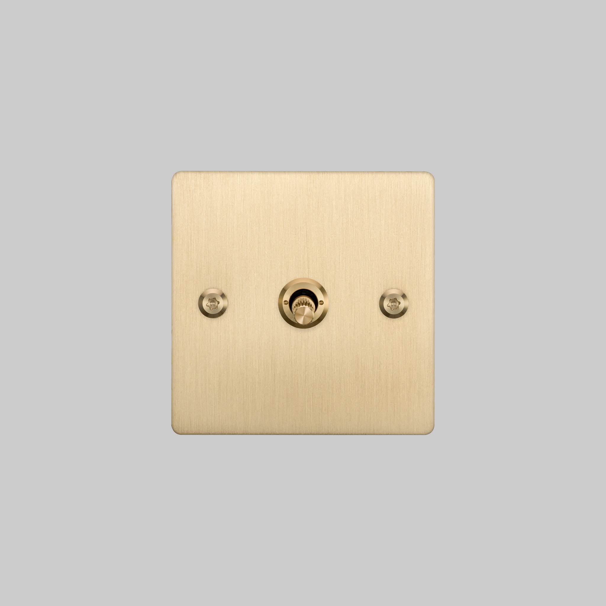 Buster + Punch 1G intermediate 3 way toggle switch, Brass plate with Brass linear knurl toggle arm, front view