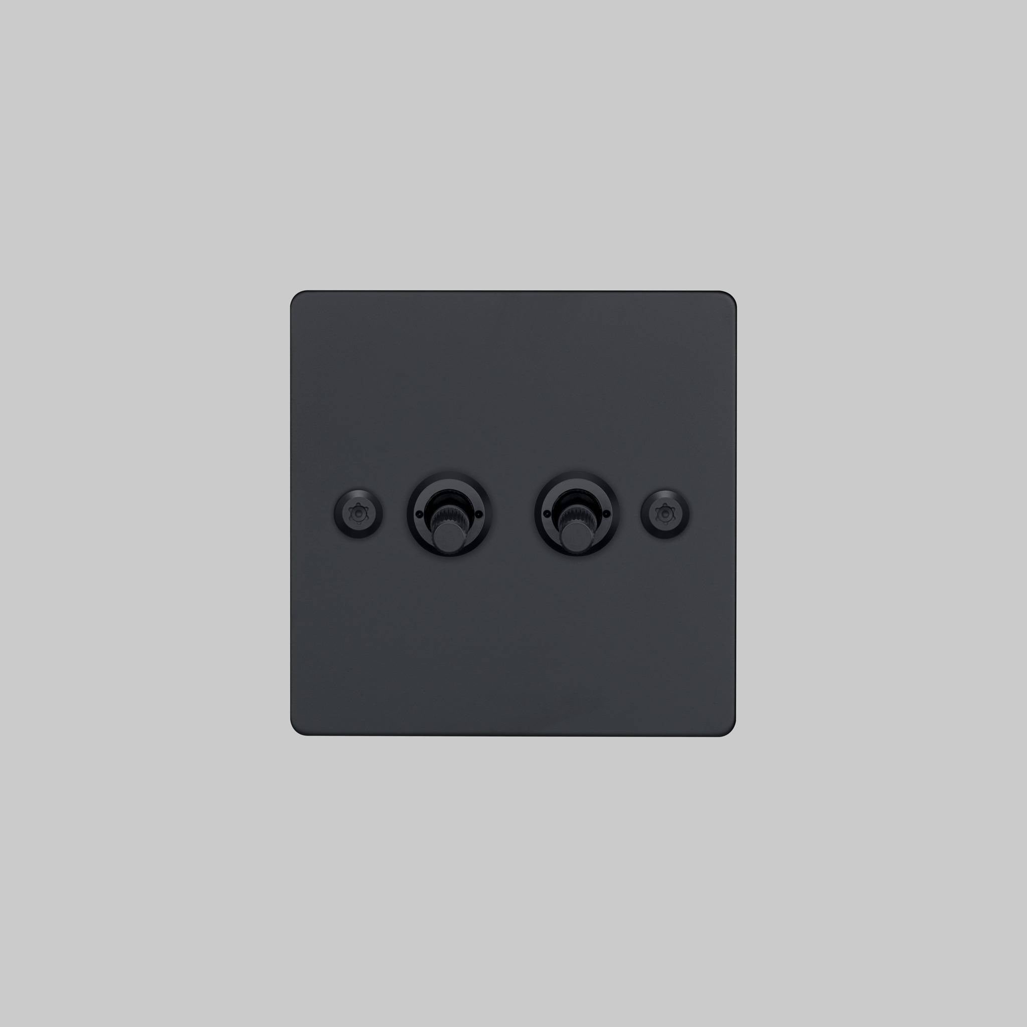 Buster + Punch 2G 2-way toggle switch, black plate with black linear knurl toggle arm, elevated angle view