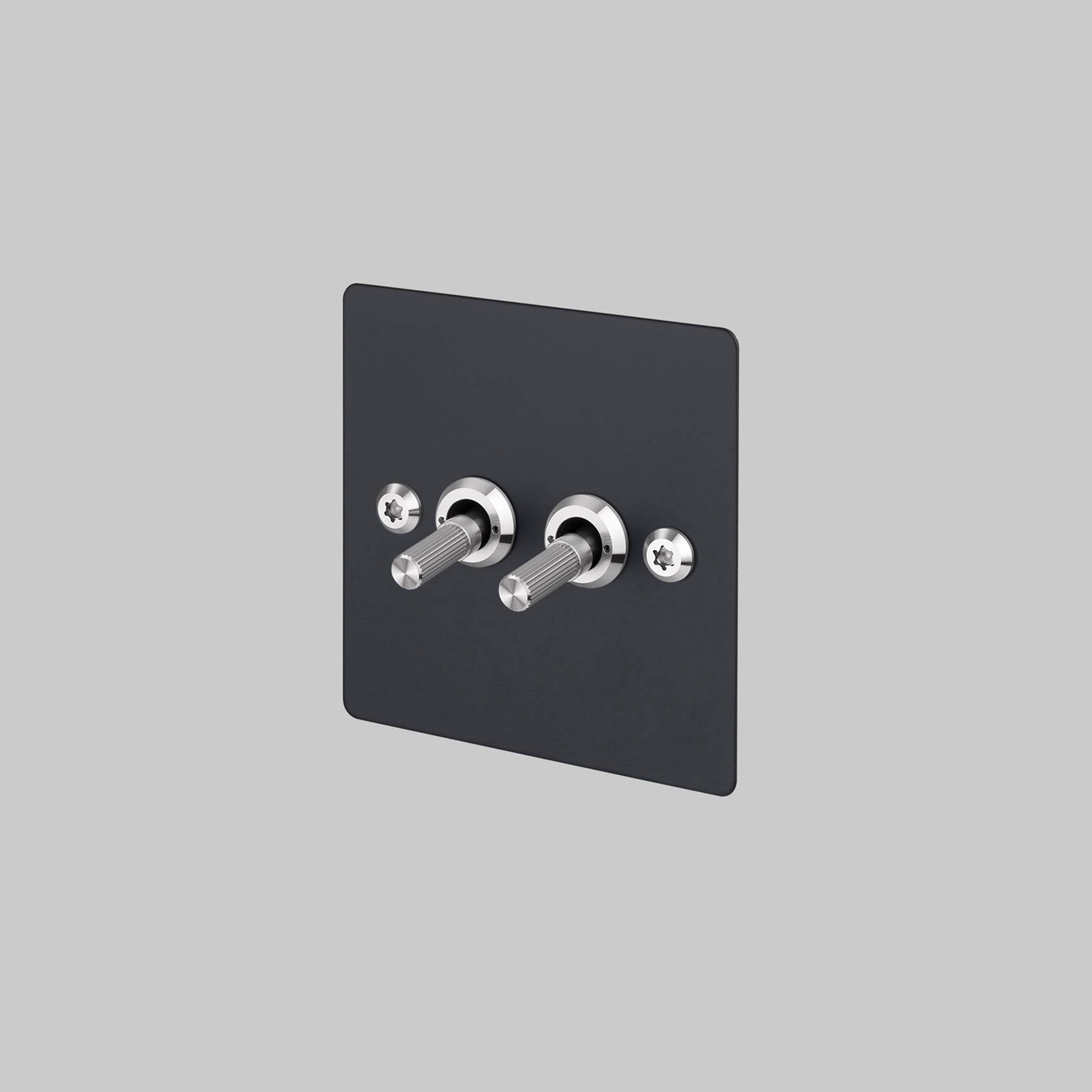 Buster + Punch 2G 2-way toggle switch, black plate with steel linear knurl toggle arm, front view