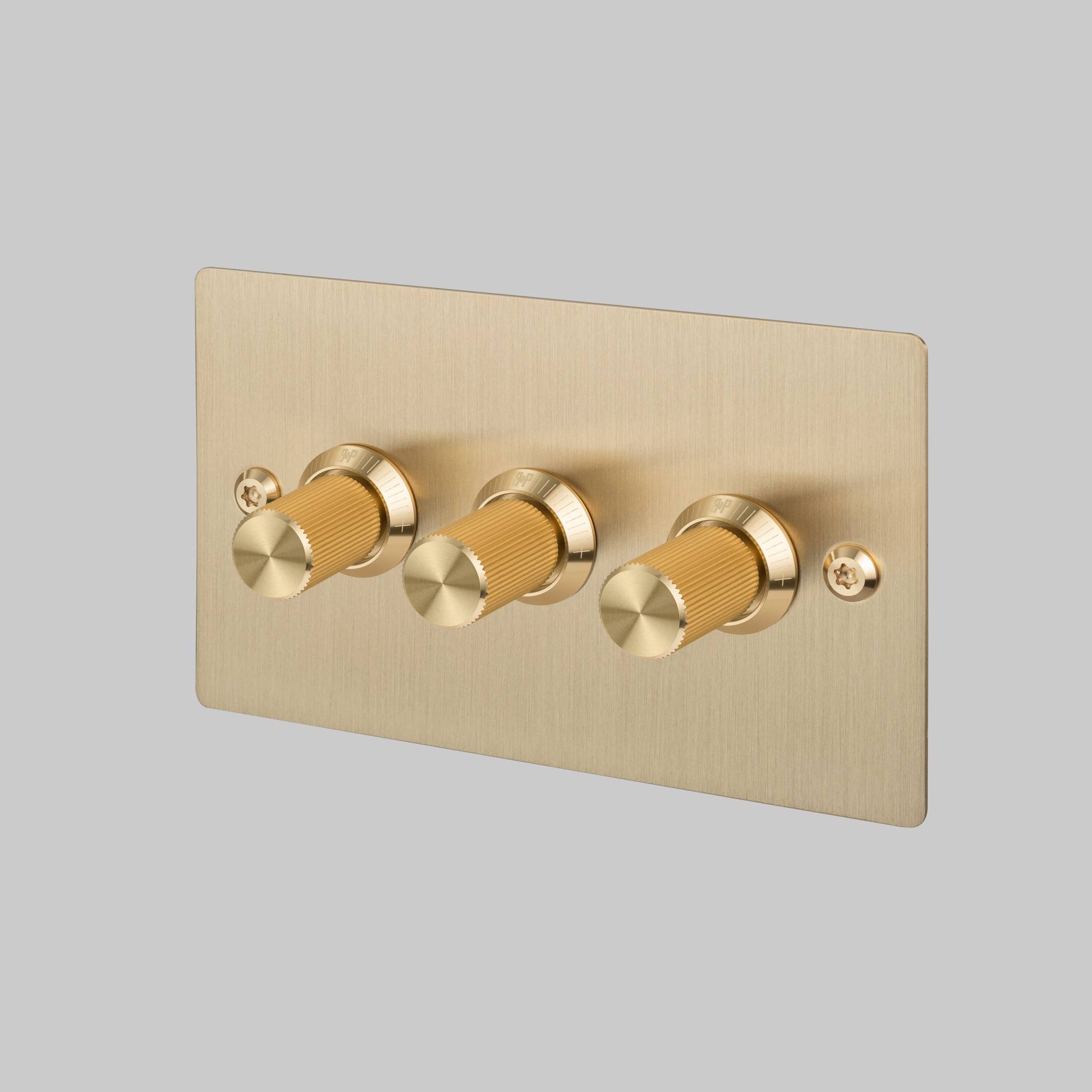 Buster + Punch 3G dimmer switch, brass plate with brass linear knurl knobs, front view
