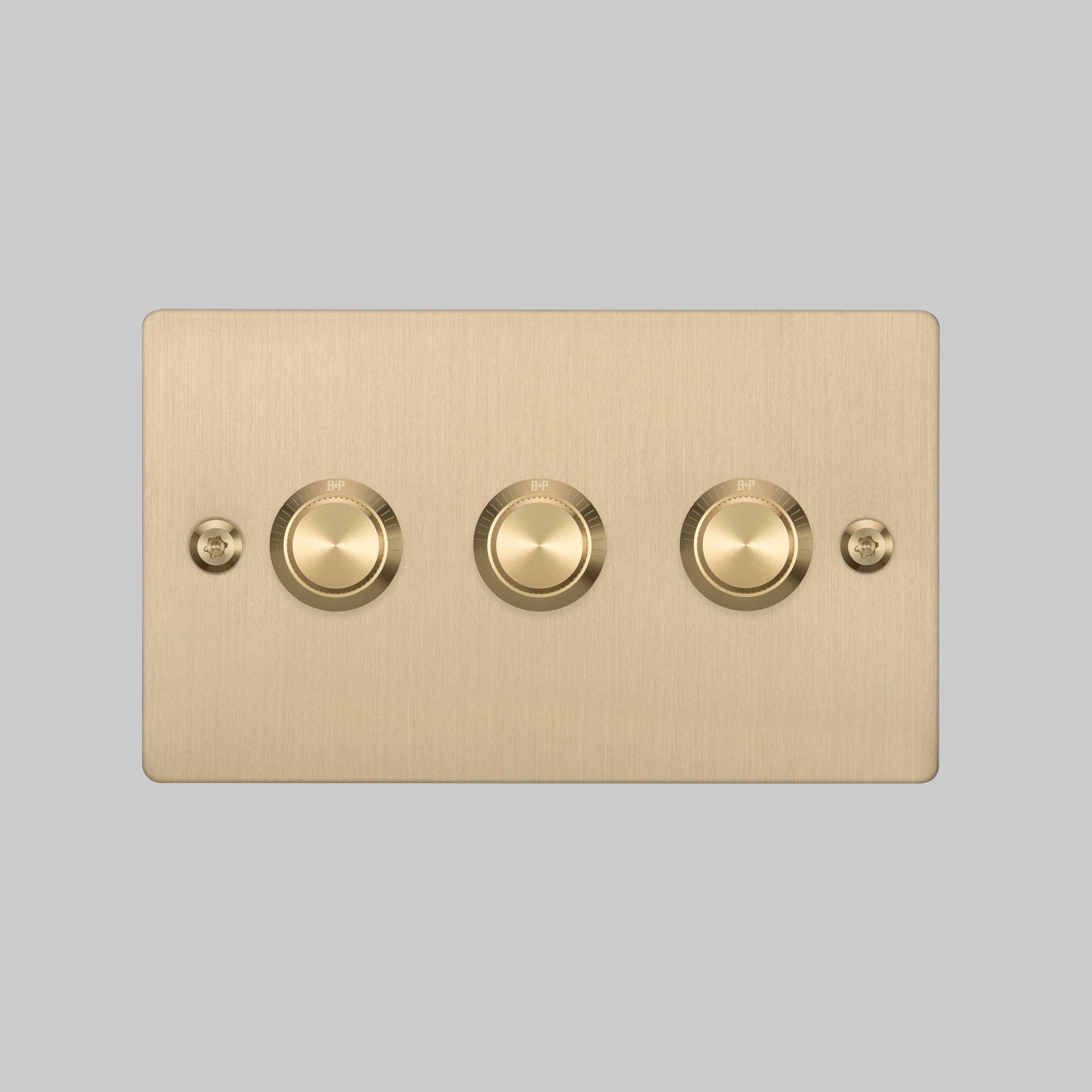 Buster + Punch 3G dimmer switch, brass plate with brass linear knurl knobs, elevated angle view