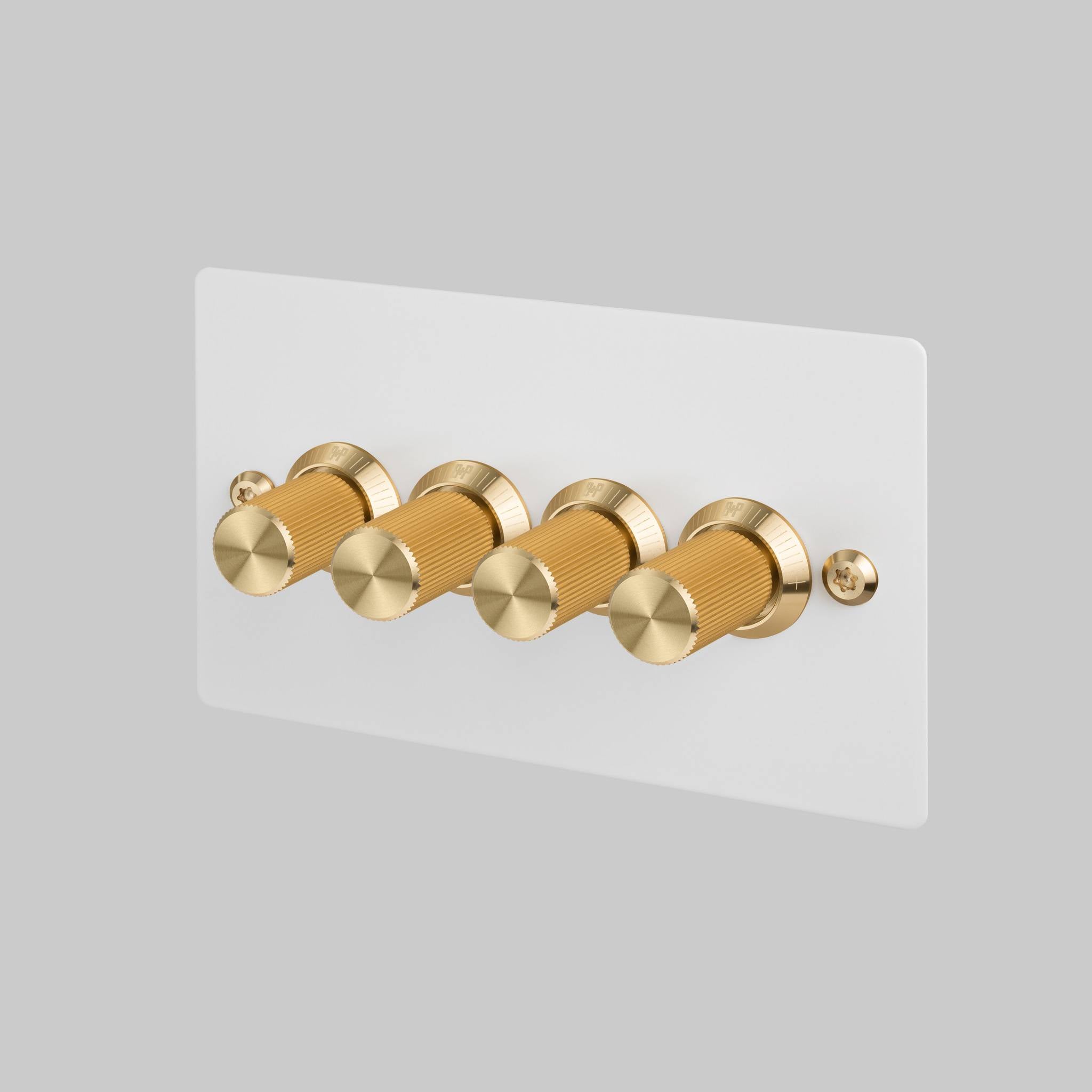 Buster + Punch 4G dimmer switch, white plate with brass linear knurl knobs, front view