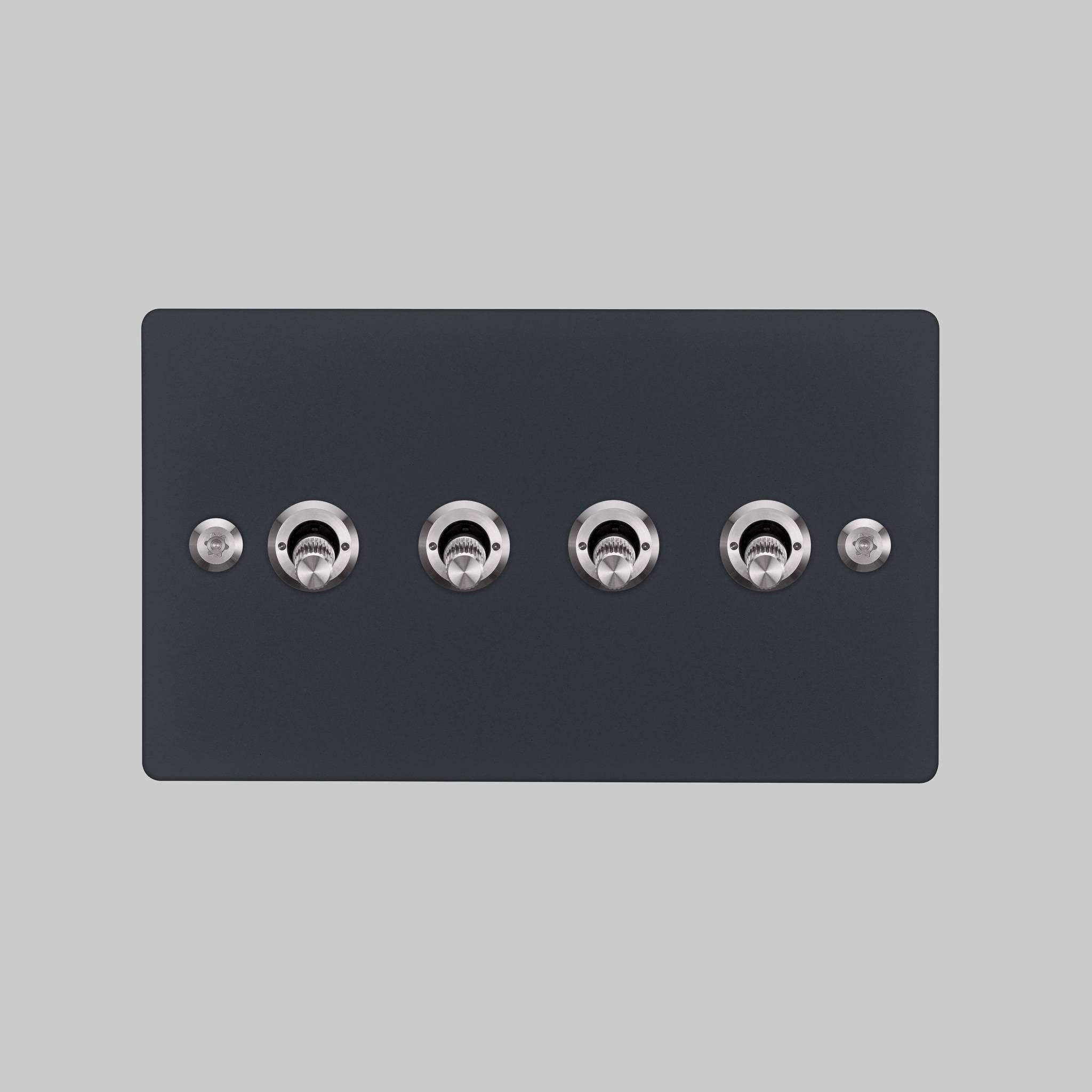 Buster + Punch 4G toggle switch, black plate with steel linear knurl toggle arms, elevated angle view