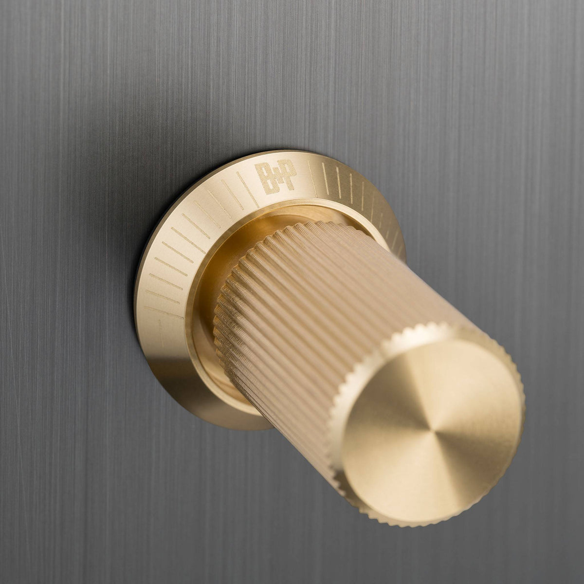 Buster + Punch 2G dimmer switch, smoked bronze plate with brass linear knurl knobs, close up of the knurl detail