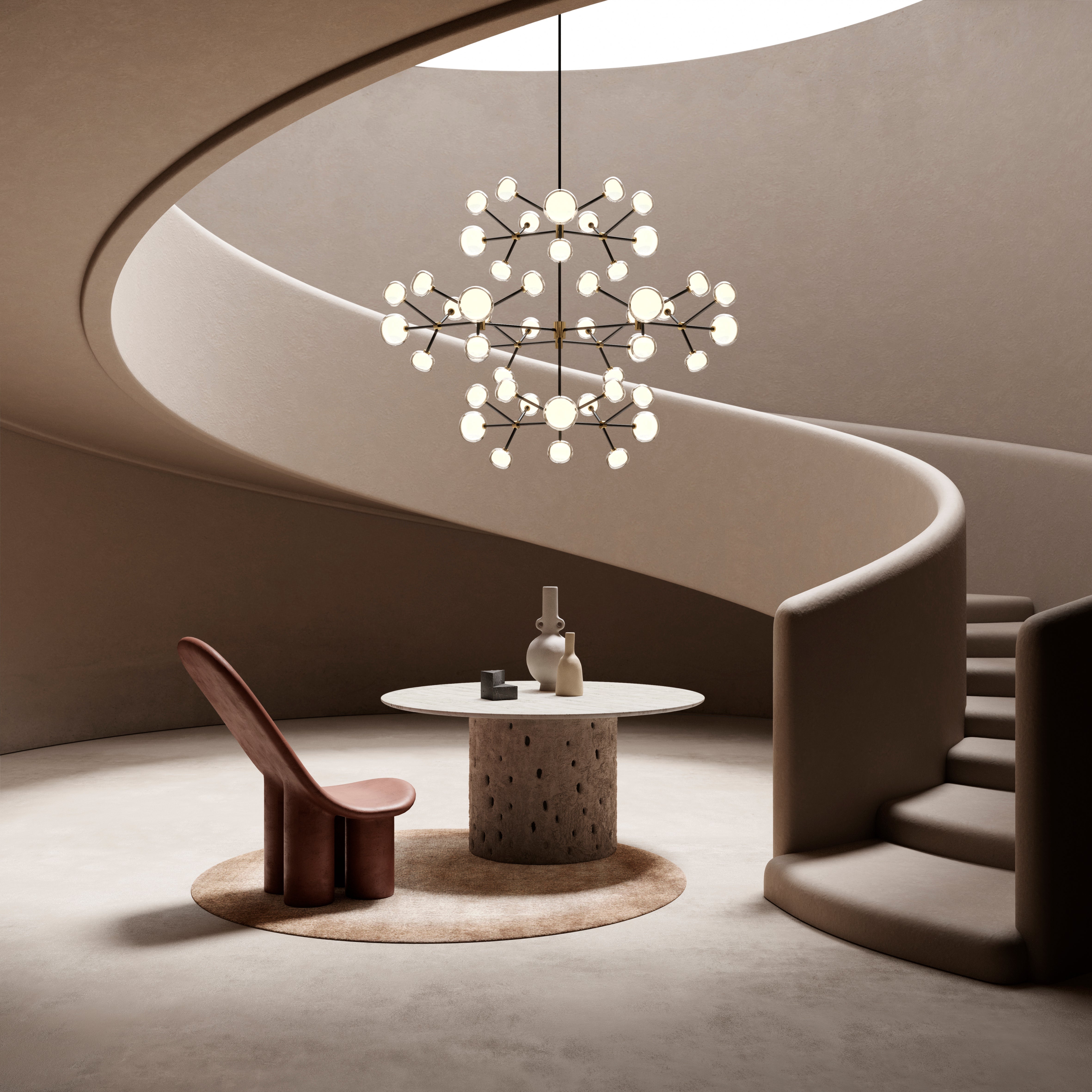 Tooy NABILA chandelier in sweeping stairs above a table and chair