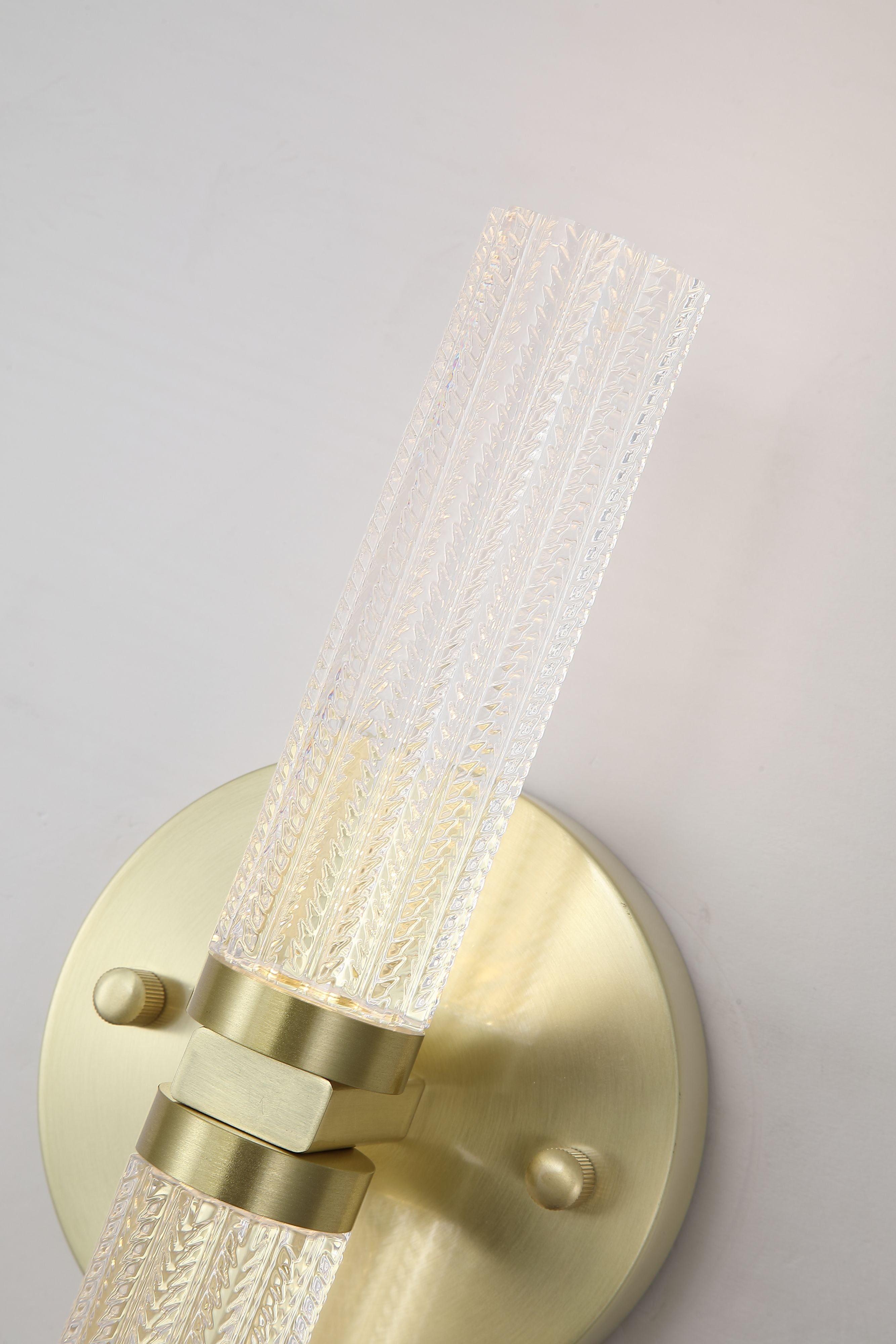 Close up of the Aberdeen Up/Down wall light's upper fluted diffuser and satin brass mounting bracket