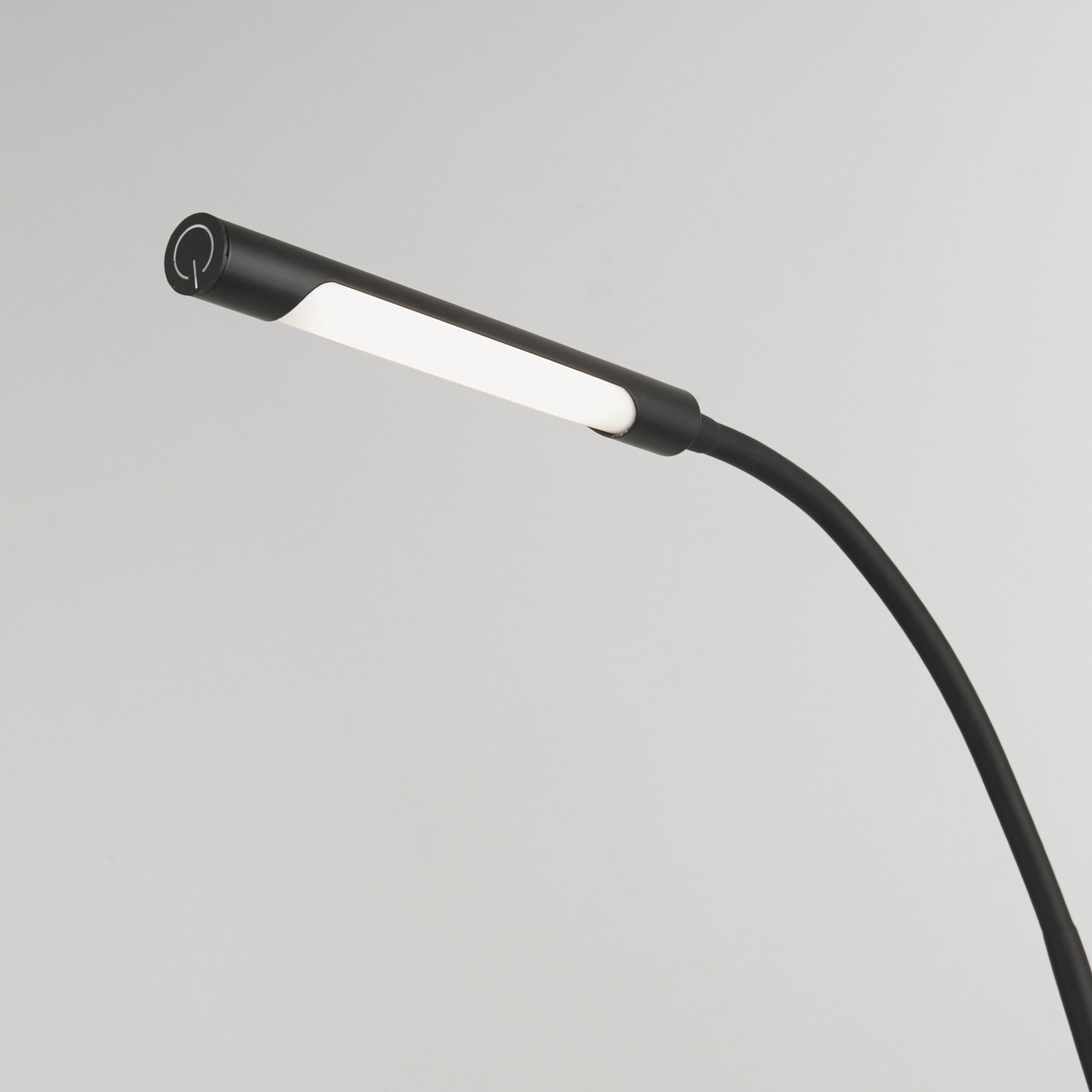 Close up of the Plume Floor Lamp LED head showing the touch power button and linear light strip