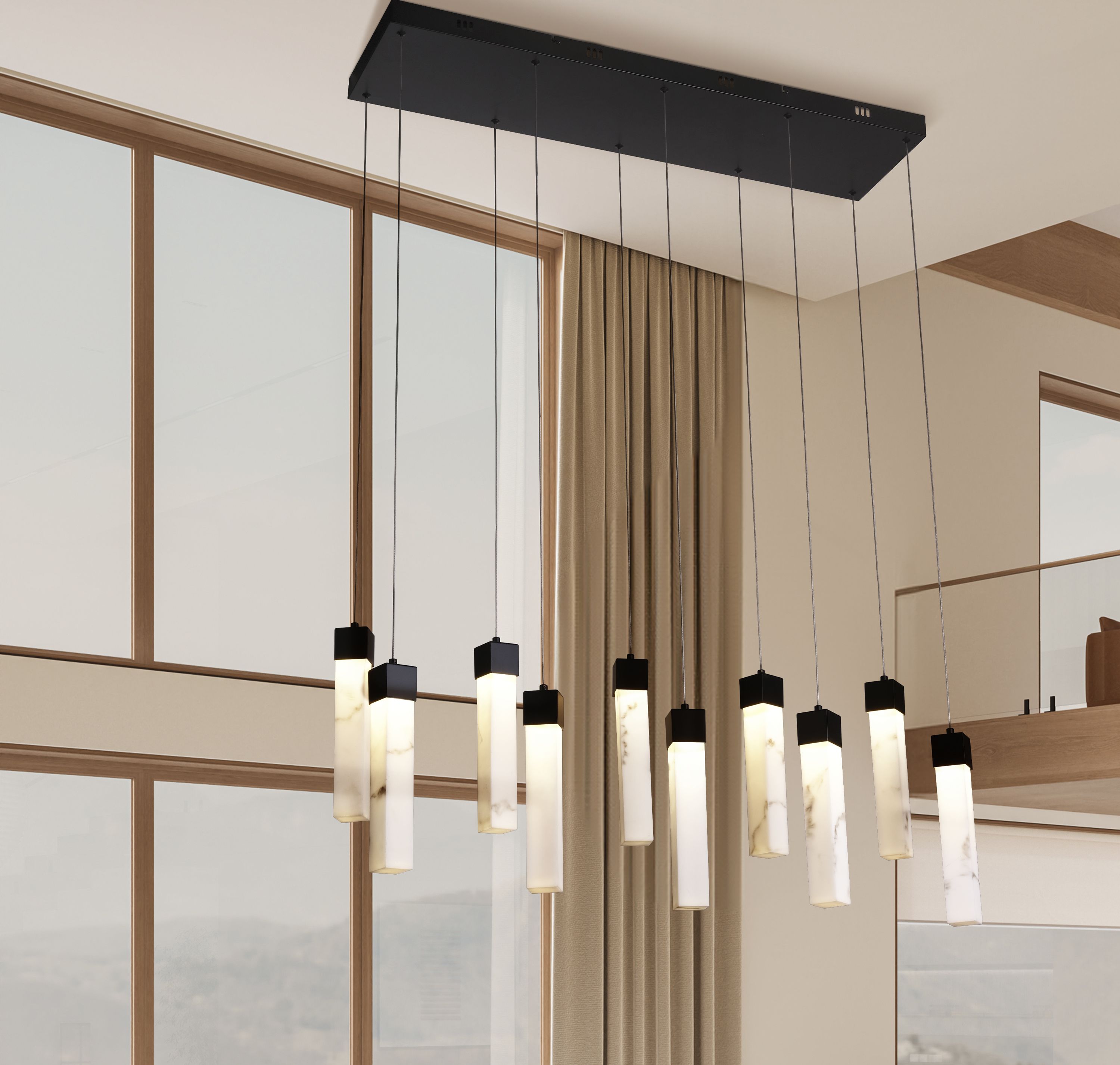 Moonbeam 10 light pendant hung in a living space with floor to ceiling windows and curtains, ten drops lit at staggered heights