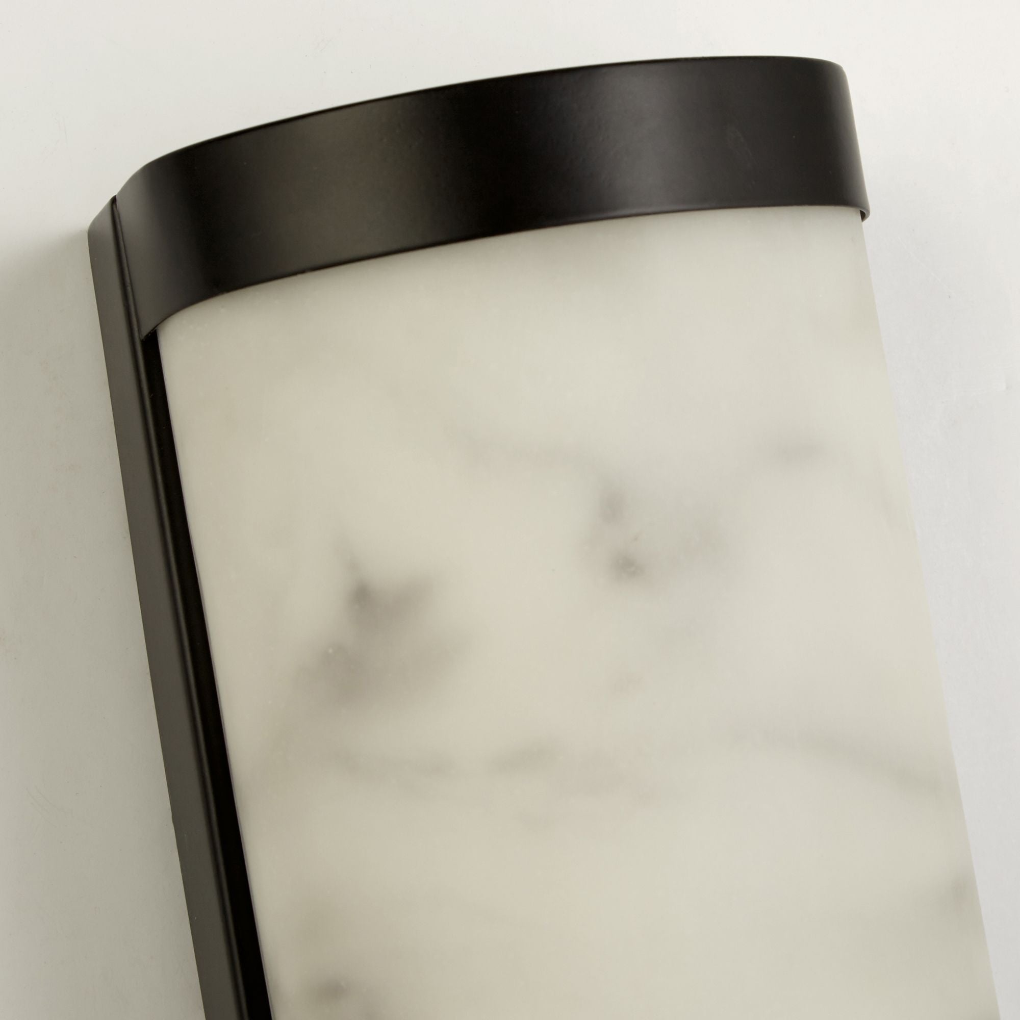 Close up of the marble effect resin diffuser on the Searchlight Nile LED Wall Light, showing the grey veining against the black frame edge