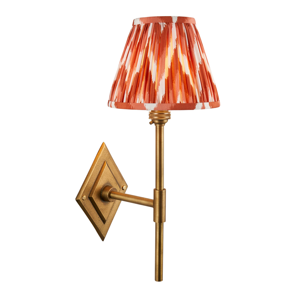 Endon Diamond Tall wall light, antique brass with apricot orange zigzag shade, lit, cut out on white showing the diamond backplate and stem