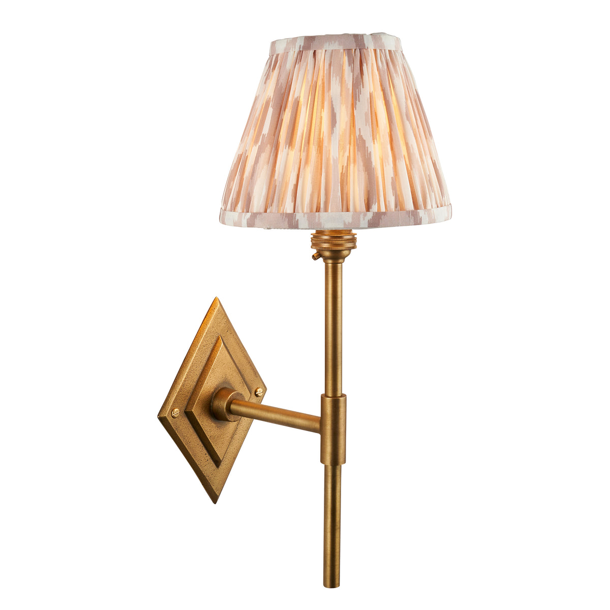 Endon Diamond Tall wall light lit, cut out on white, antique brass diamond backplate and stem with a glowing neutral ikat pleated shade