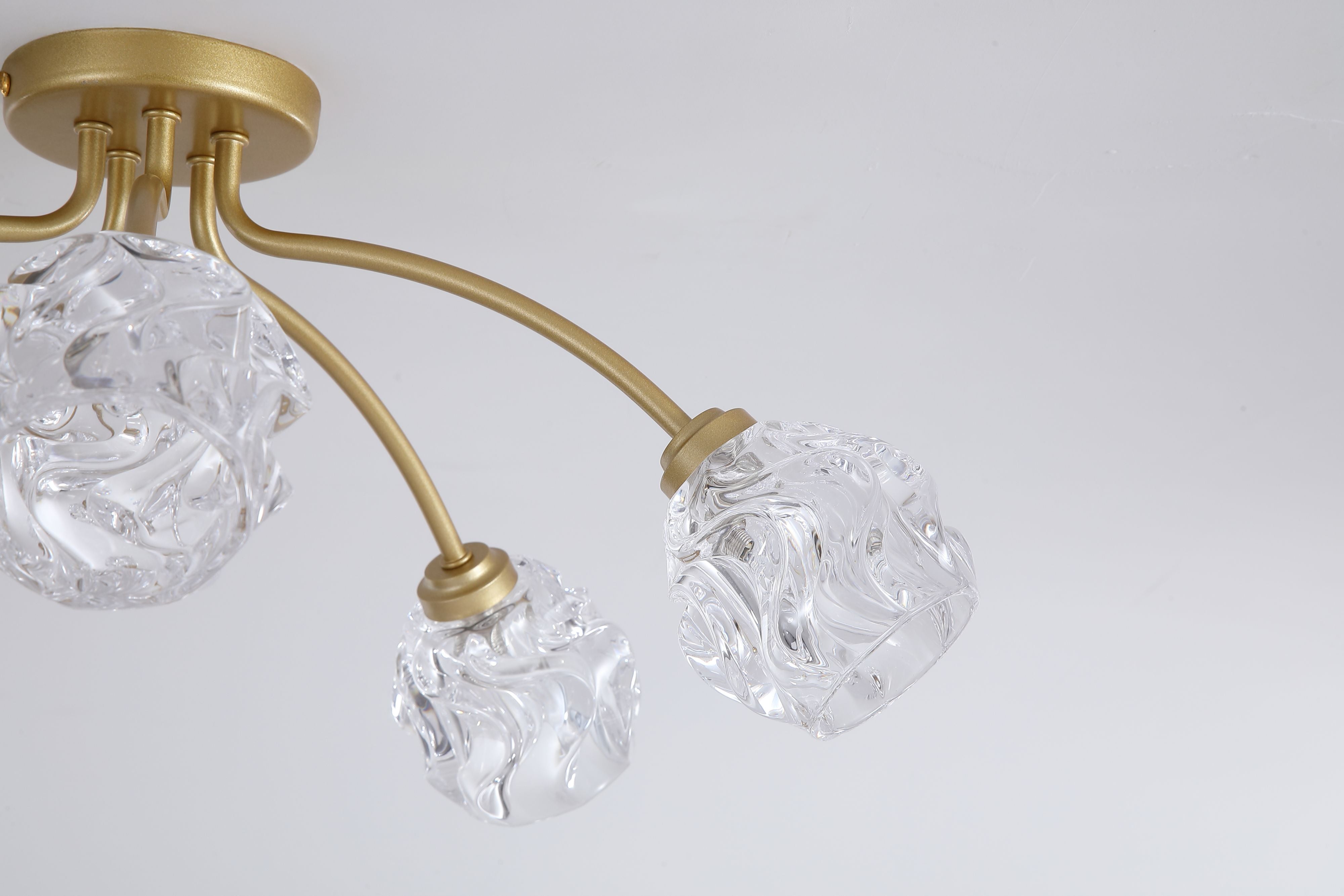 Close up of the Searchlight Astral 5 Light Flush in gold showing the ceiling plate and the crumpled texture of the glass shades