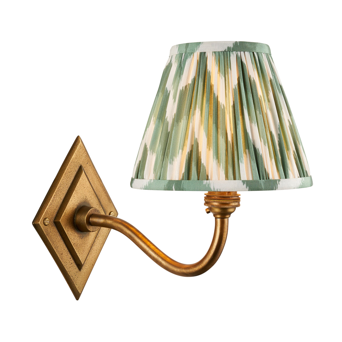 Endon Diamond Curve wall light in antique brass with a Cotswold green zigzag pleated shade, lit, cut out on a white background