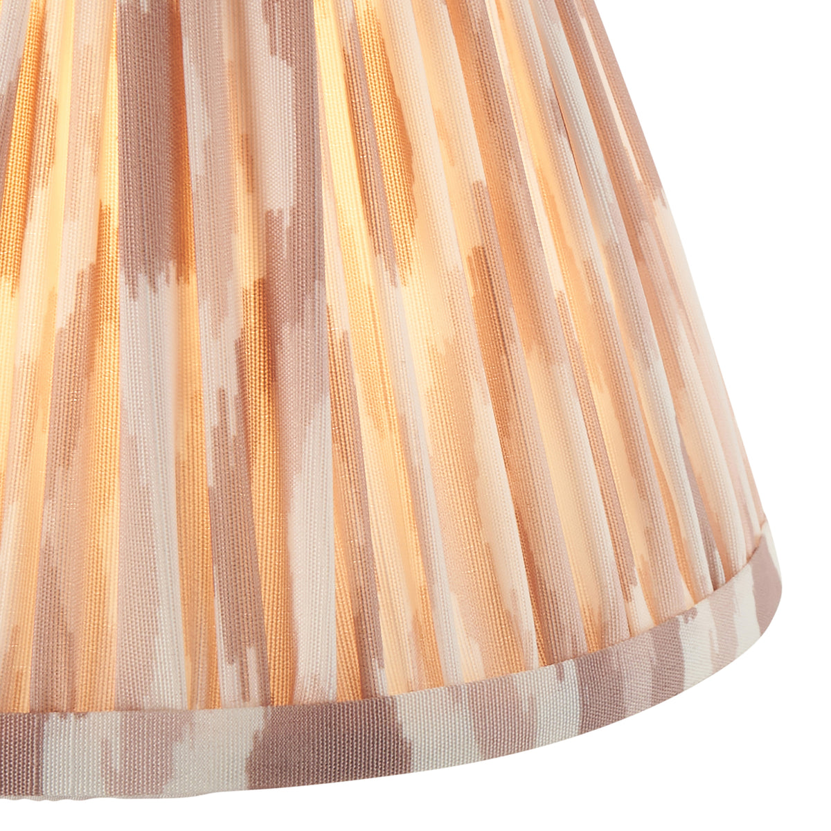 Close up of the lit Endon Ikat 16cm shade for the Diamond Curve wall light, gathered pleats in blush, beige and white faux silk