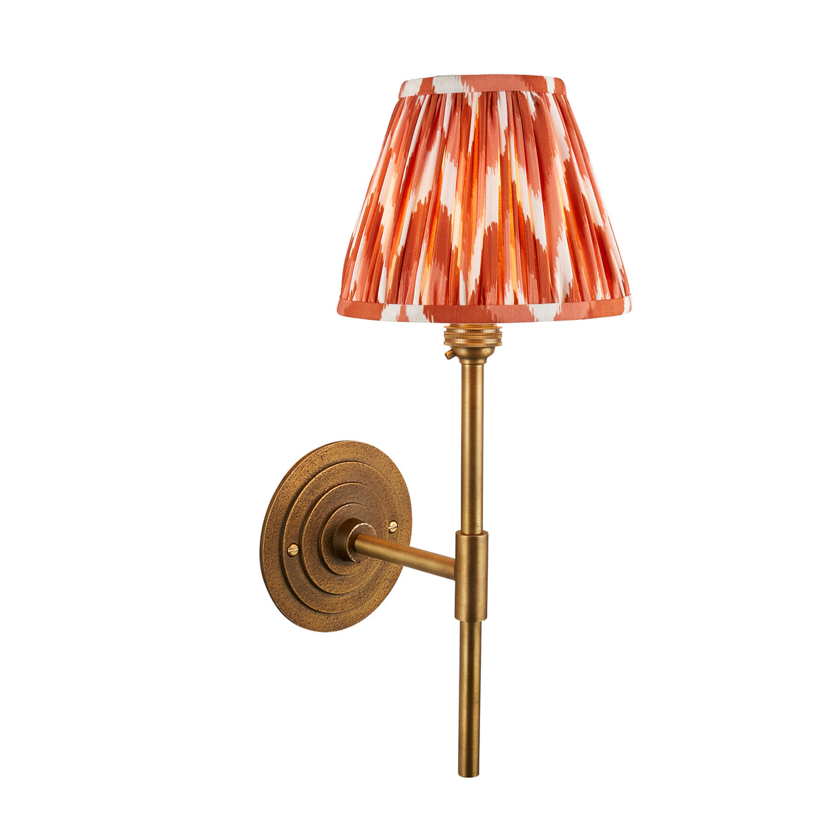 Endon Halo Tall wall light in antique brass with apricot orange zigzag pleated shade, unlit, cut out on white