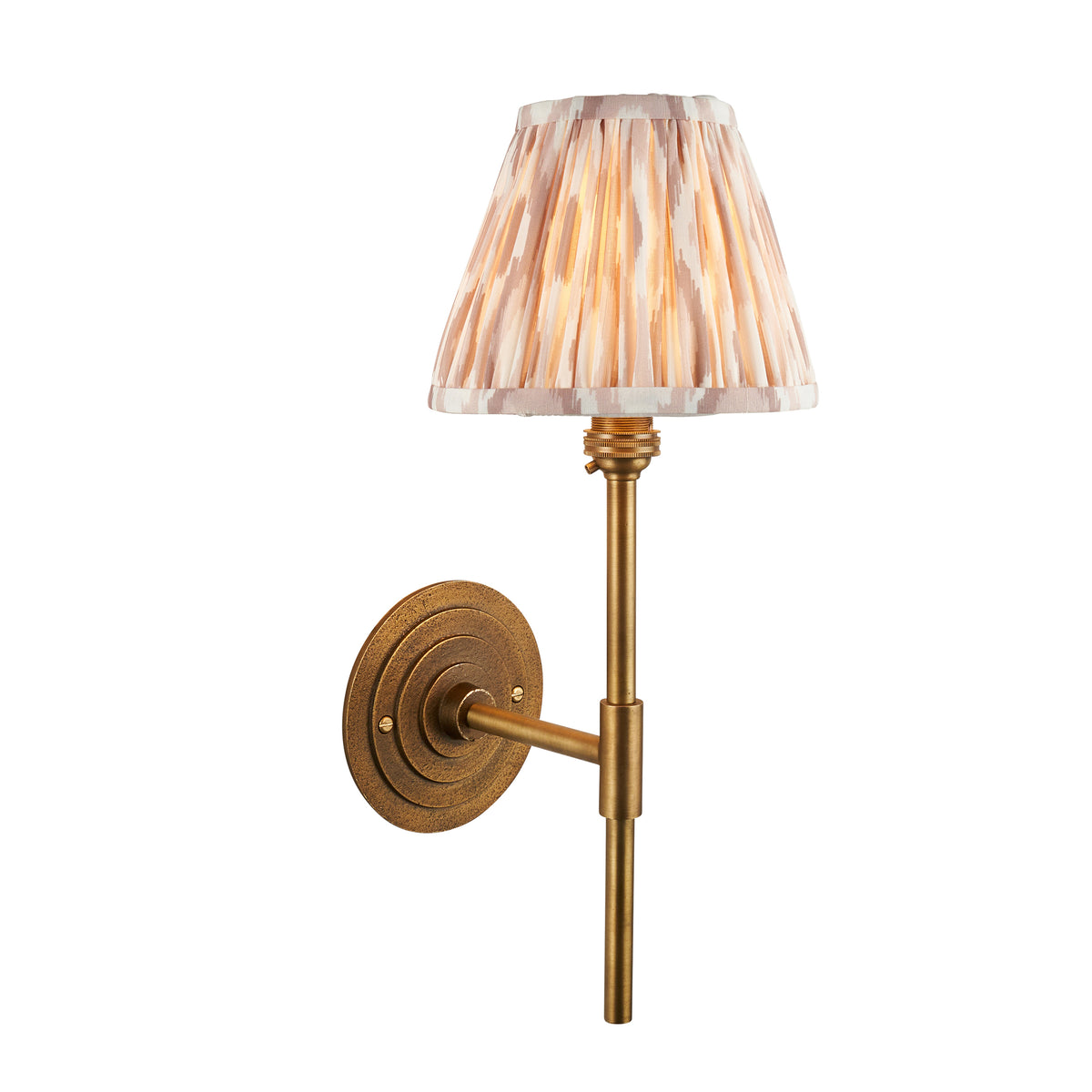 Endon Halo Tall wall light in antique brass with a 16cm pleated neutral Ikat fabric shade, lit, cut out on white