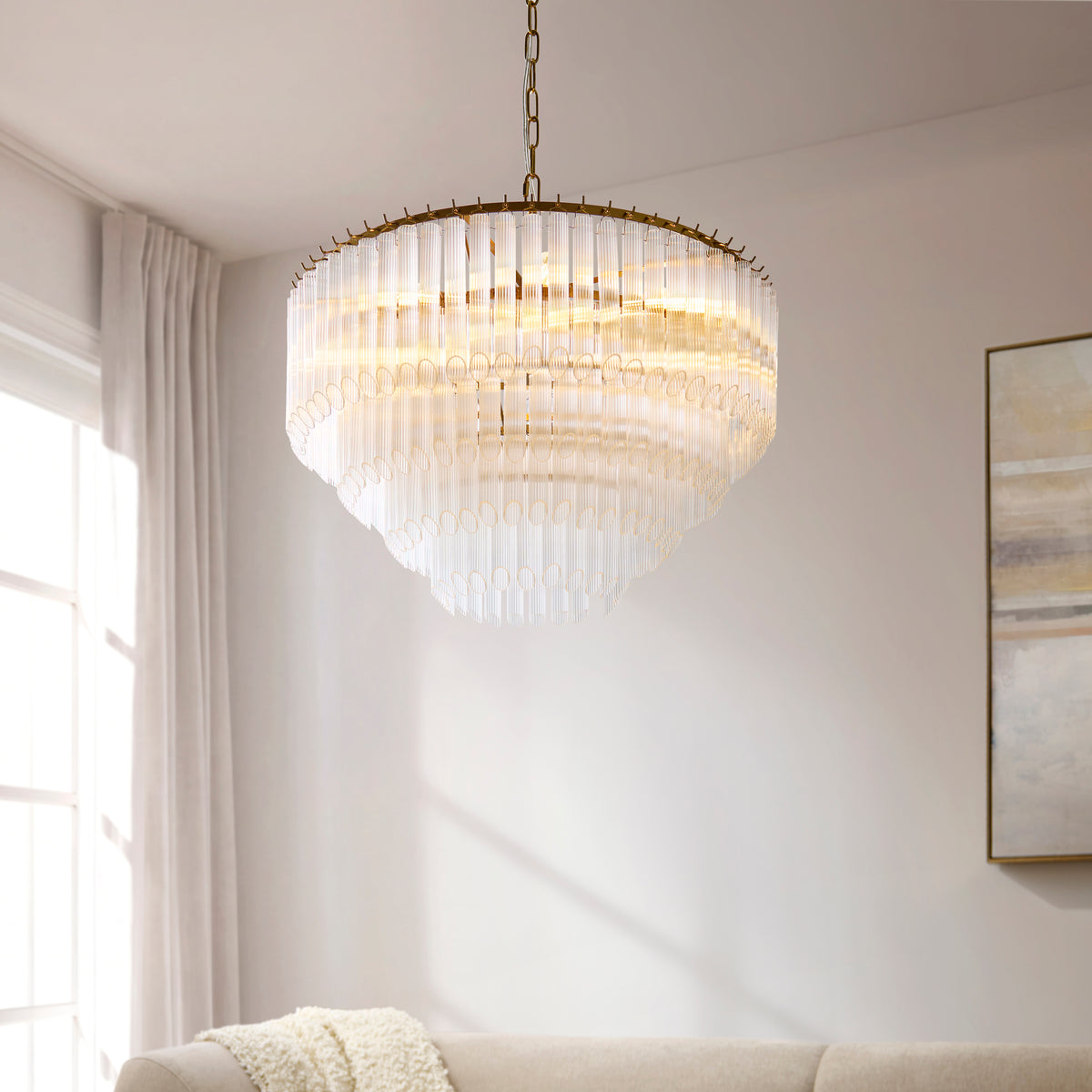 Close up angled shot of the Endon Montpellier 6 light pendant in brushed aged brass showing the clear ribbed glass rods and brass frame detail