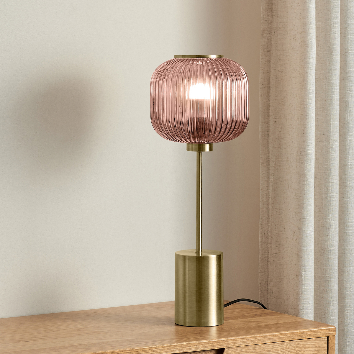 MADE.COM Briz large table lamp in antique brass with ribbed pink glass shade, lifestyle shot on an oak sideboard
