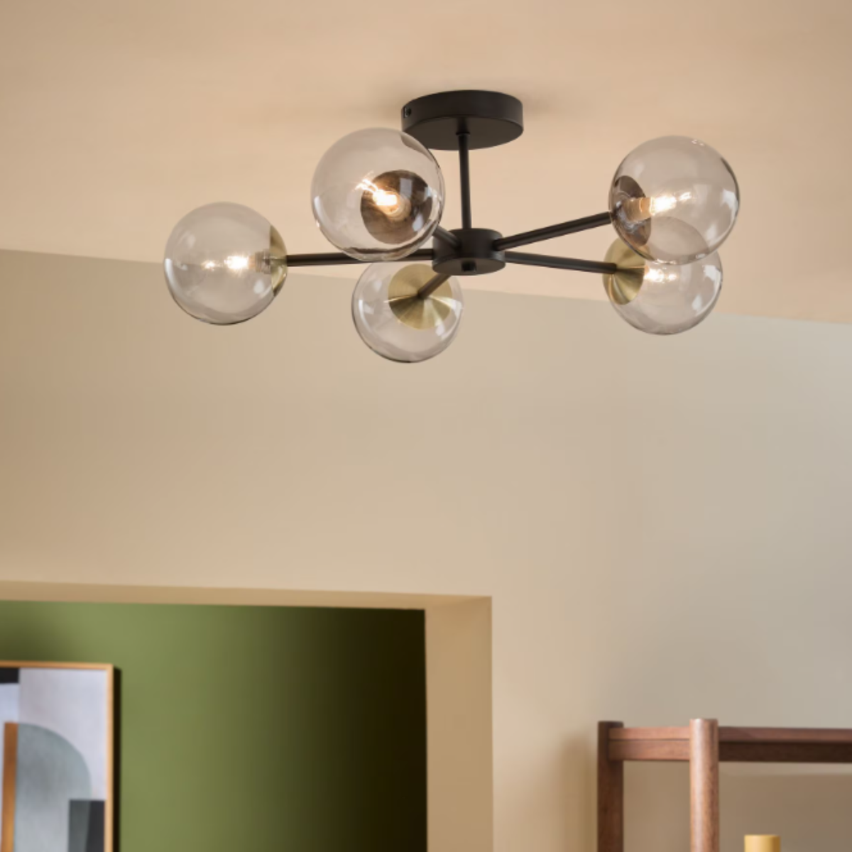MADE.COM Globe 5 light flush ceiling light in matt black with tinted glass globes, lifestyle shot in a room