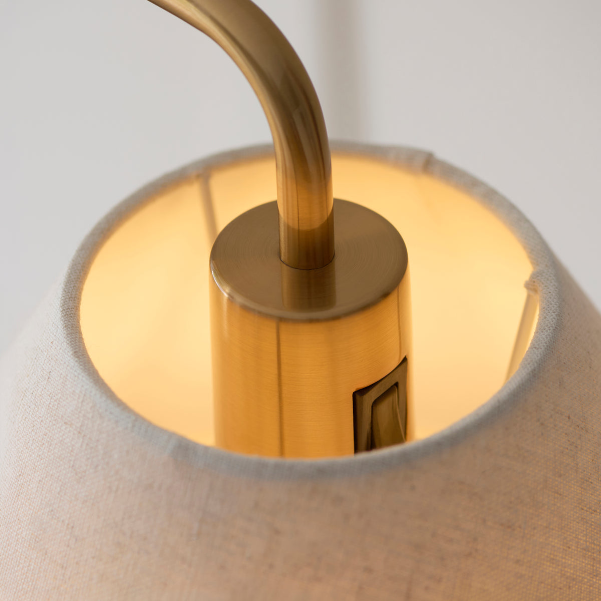 Endon Wallbridge floor light lit in a lifestyle room scene shown from a wider angle beside soft furnishings