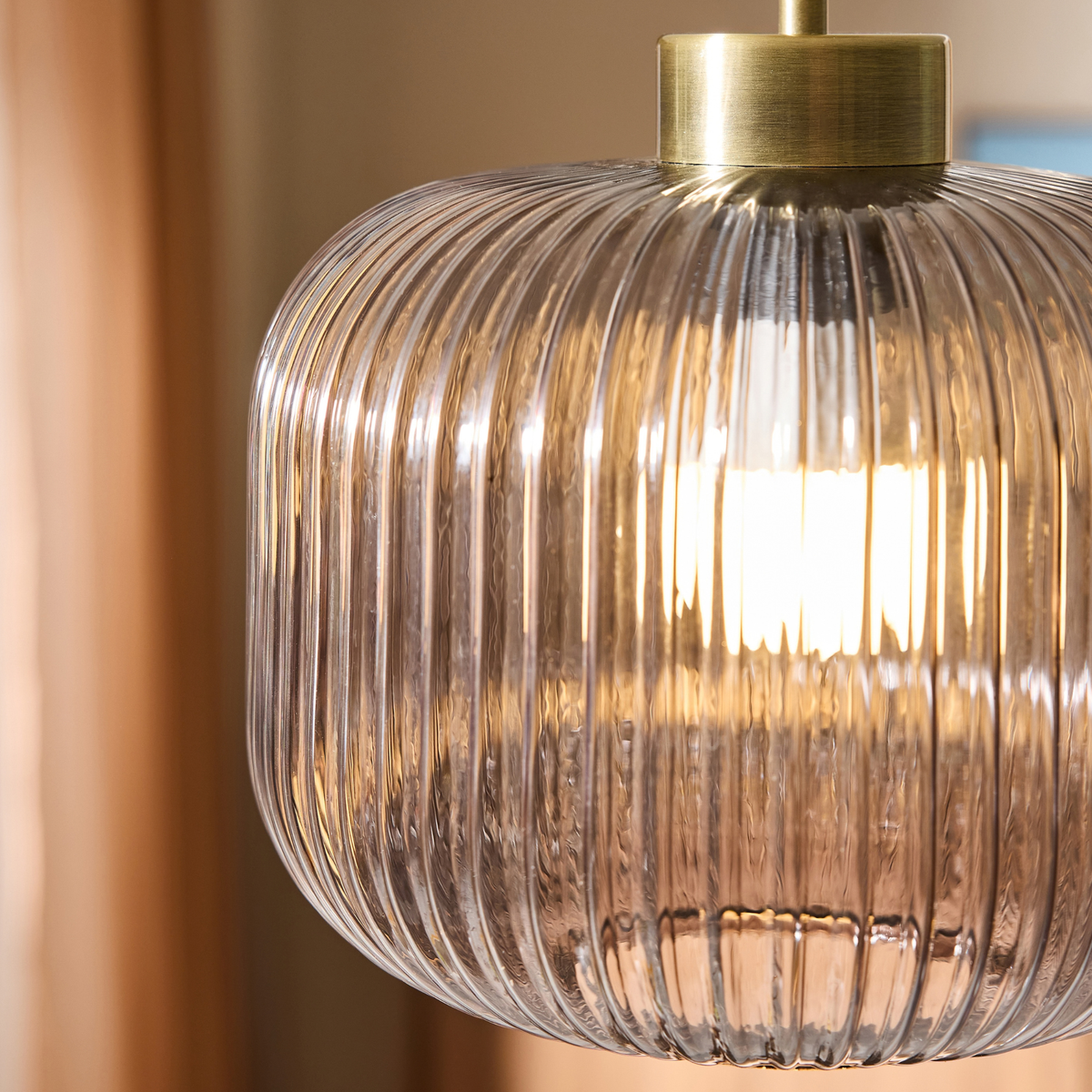 MADE Briz flush ceiling light close up of ribbed grey glass shade lit from within