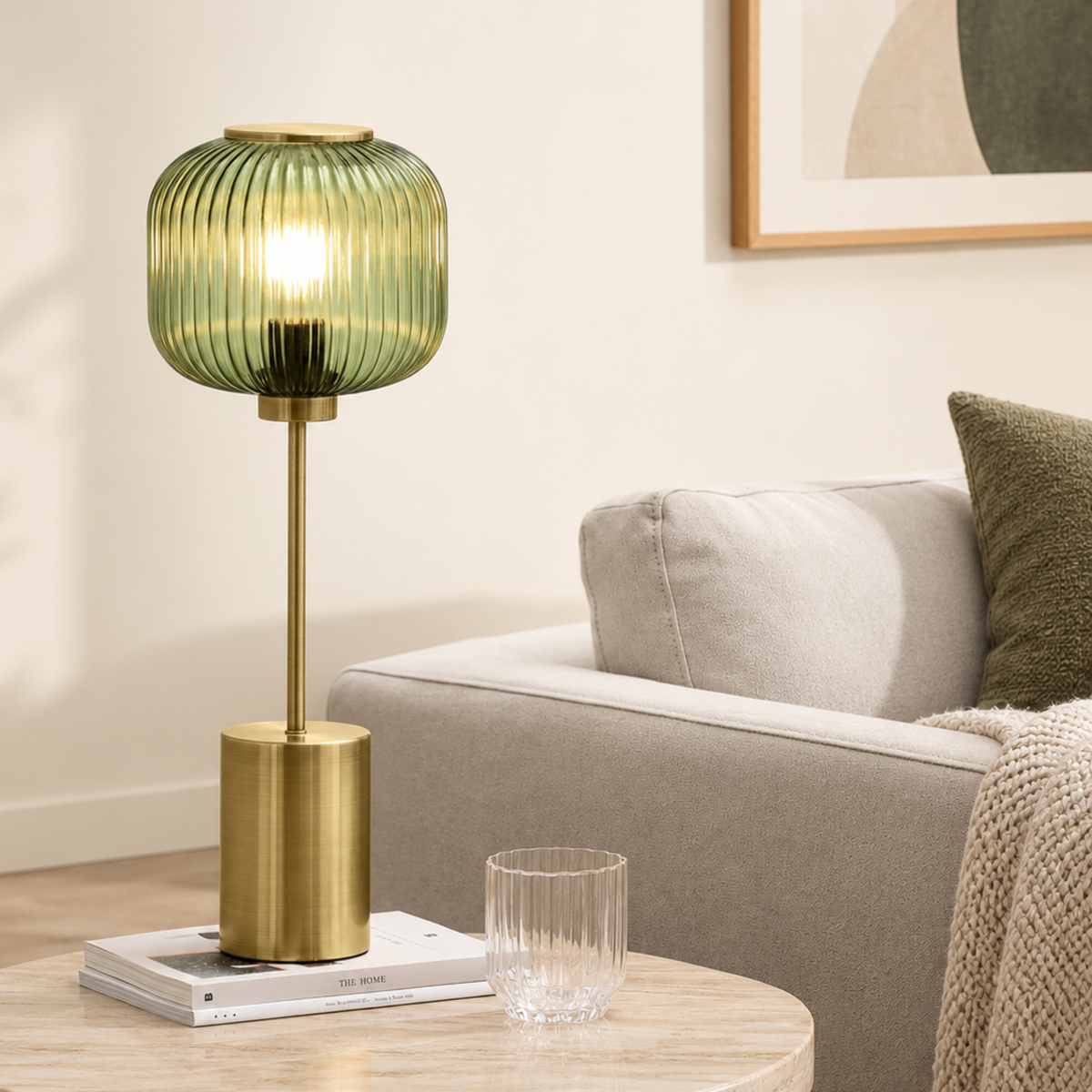 MADE.COM Briz large table lamp in brushed brass with ribbed green glass shade, lifestyle shot beside a sofa