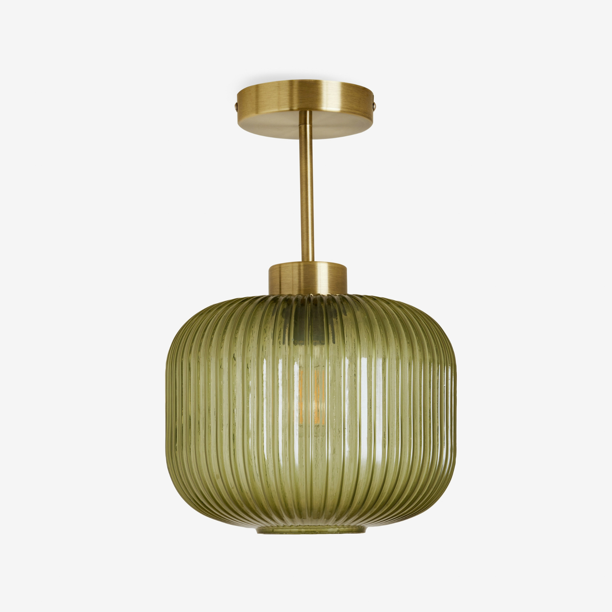MADE Briz flush ceiling light in antique brass with ribbed green glass shade, studio shot unlit