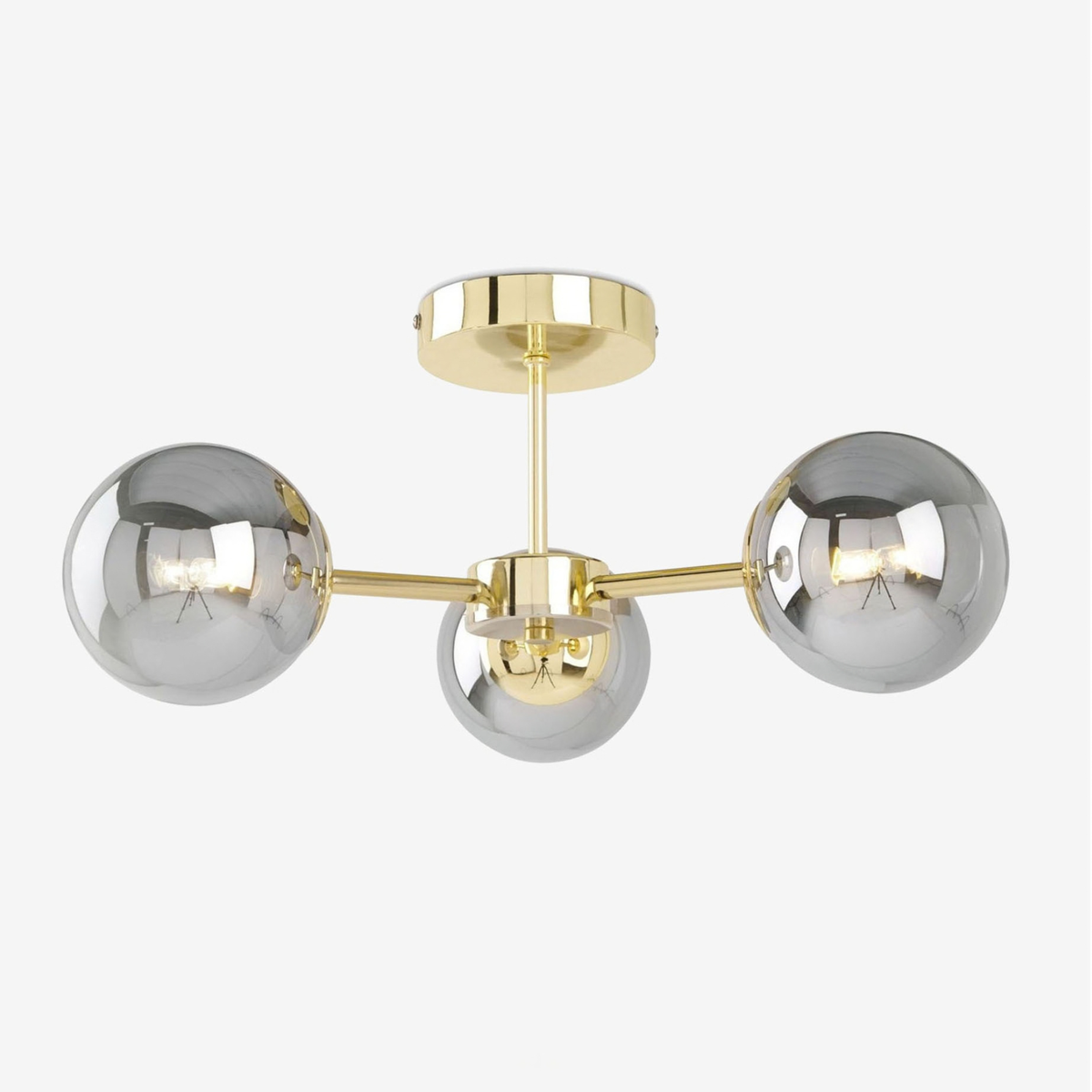 MADE Globe 3 light flush ceiling light in polished brass with smoked grey glass shades, studio shot