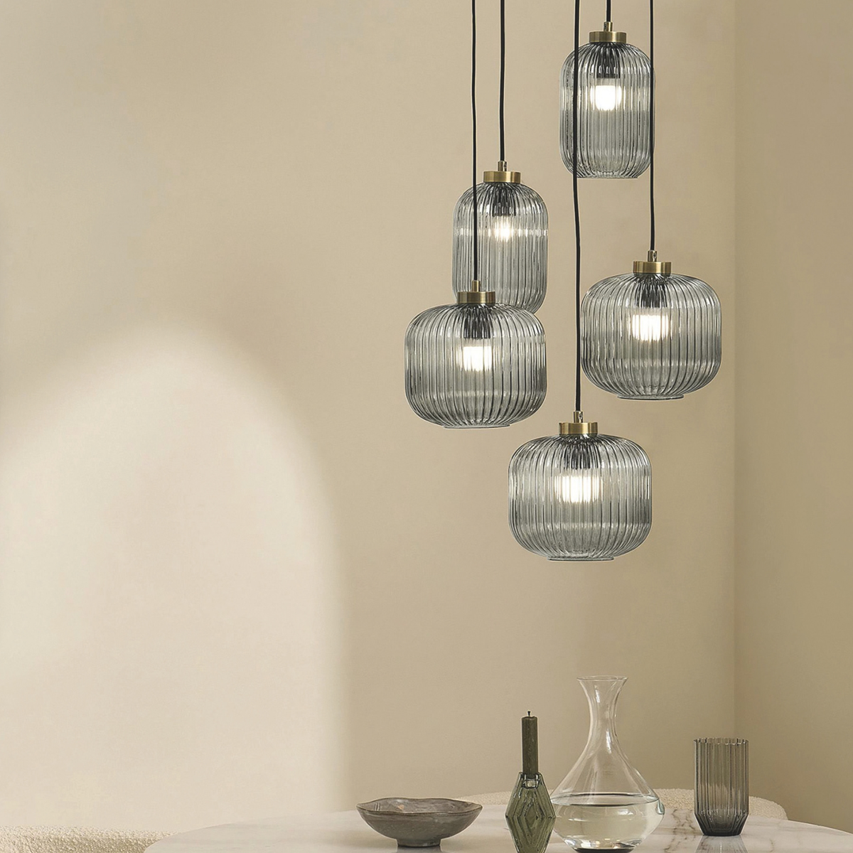 MADE.COM Briz cluster pendant with five ribbed grey glass shades hanging in a beige living room