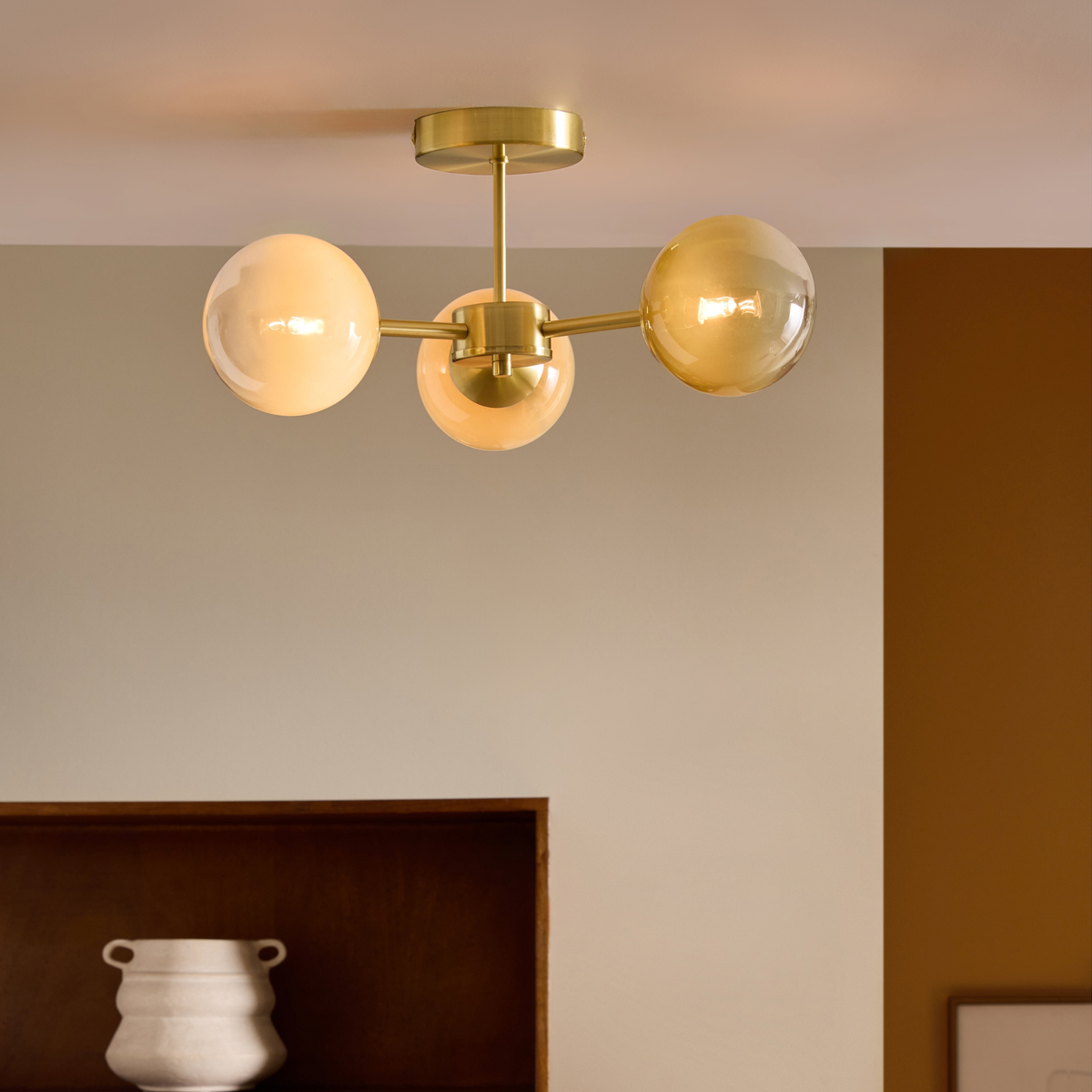 MADE.COM Globe 3 light flush ceiling light in brushed brass with green ombre globes in a room