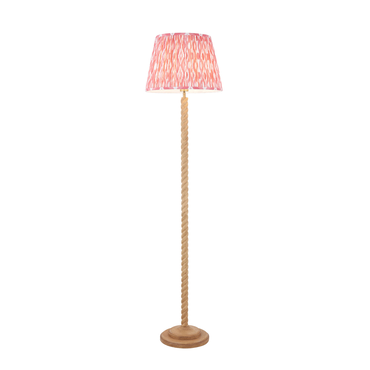 Endon Twist floor lamp in oak effect resin with a coral pink ikat shade, unlit, cut out on a white background