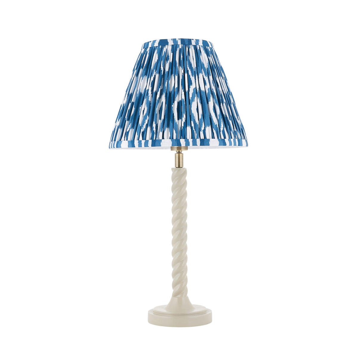 Endon Twist table lamp with a satin almond white barley twist base and a marlin blue ikat pleated shade, switched off, on a white background